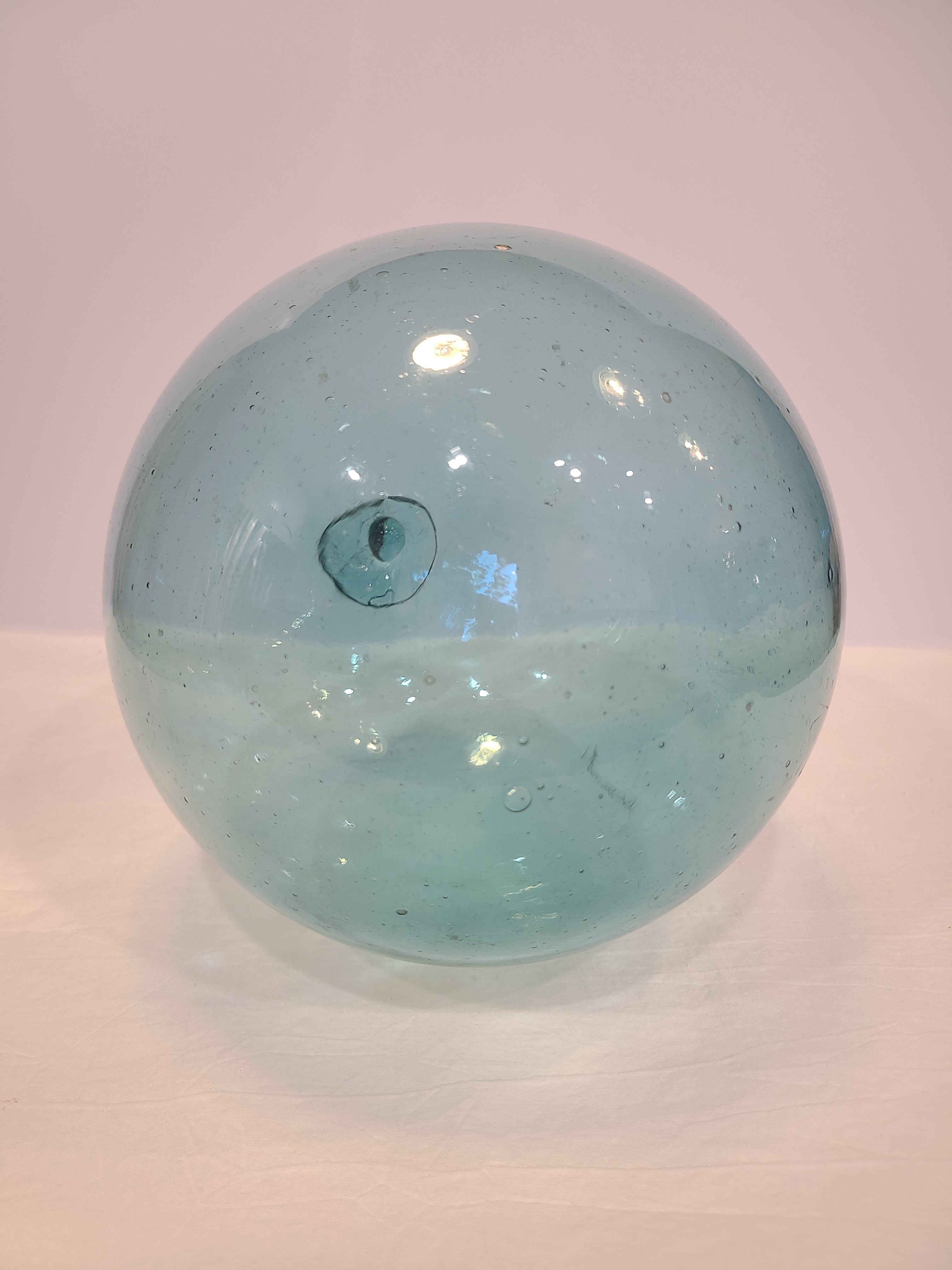 Authentic Glass Fishing Float 7" diameter in classic blue-green on light background.