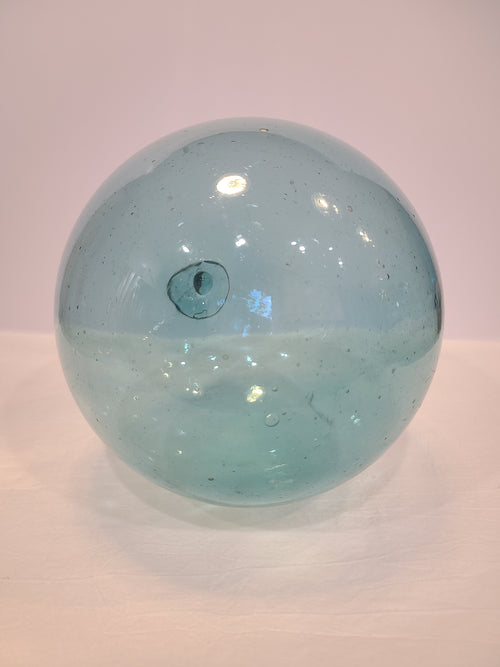 Authentic Glass Fishing Float 7" diameter in classic blue-green on light background.