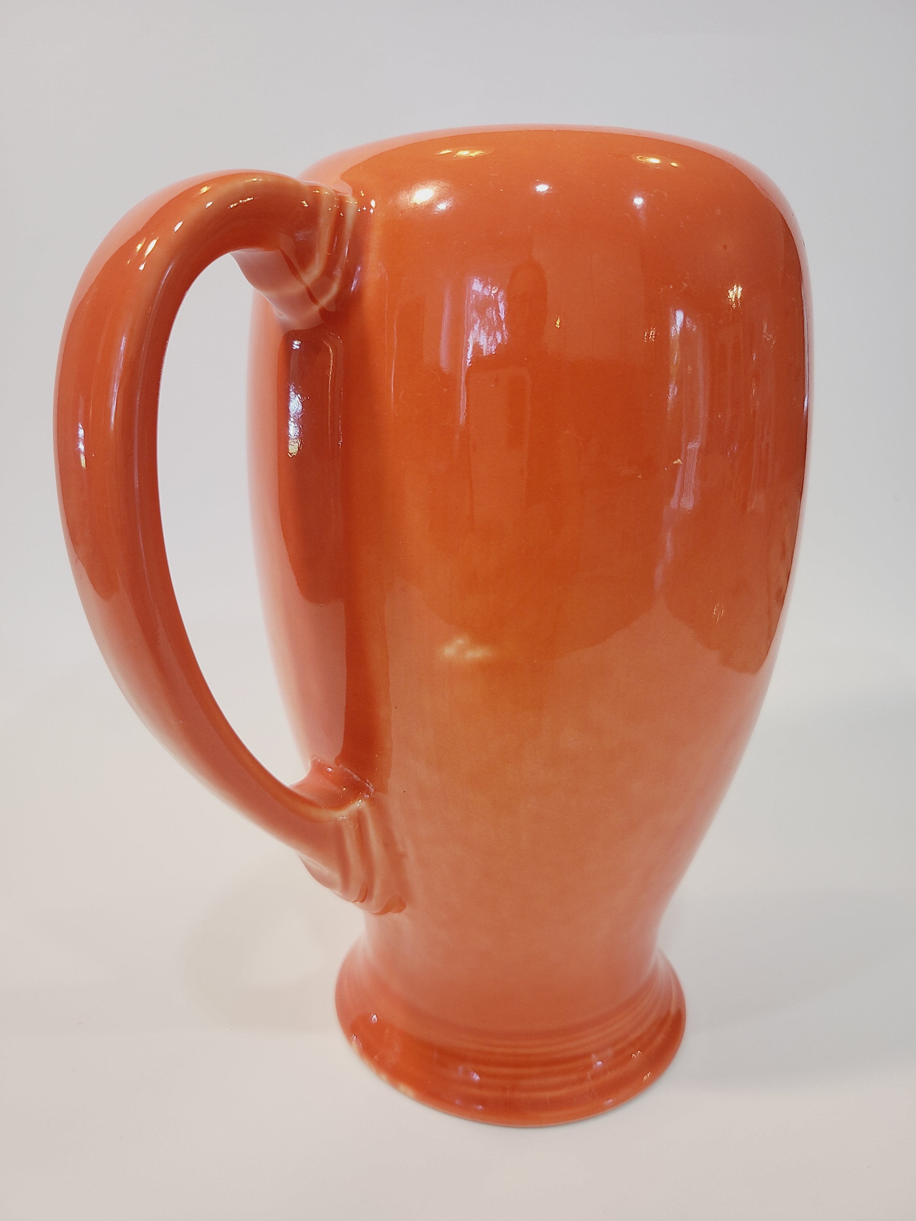 Fiesta carafe in color Persimmon showing glaze imperfection.