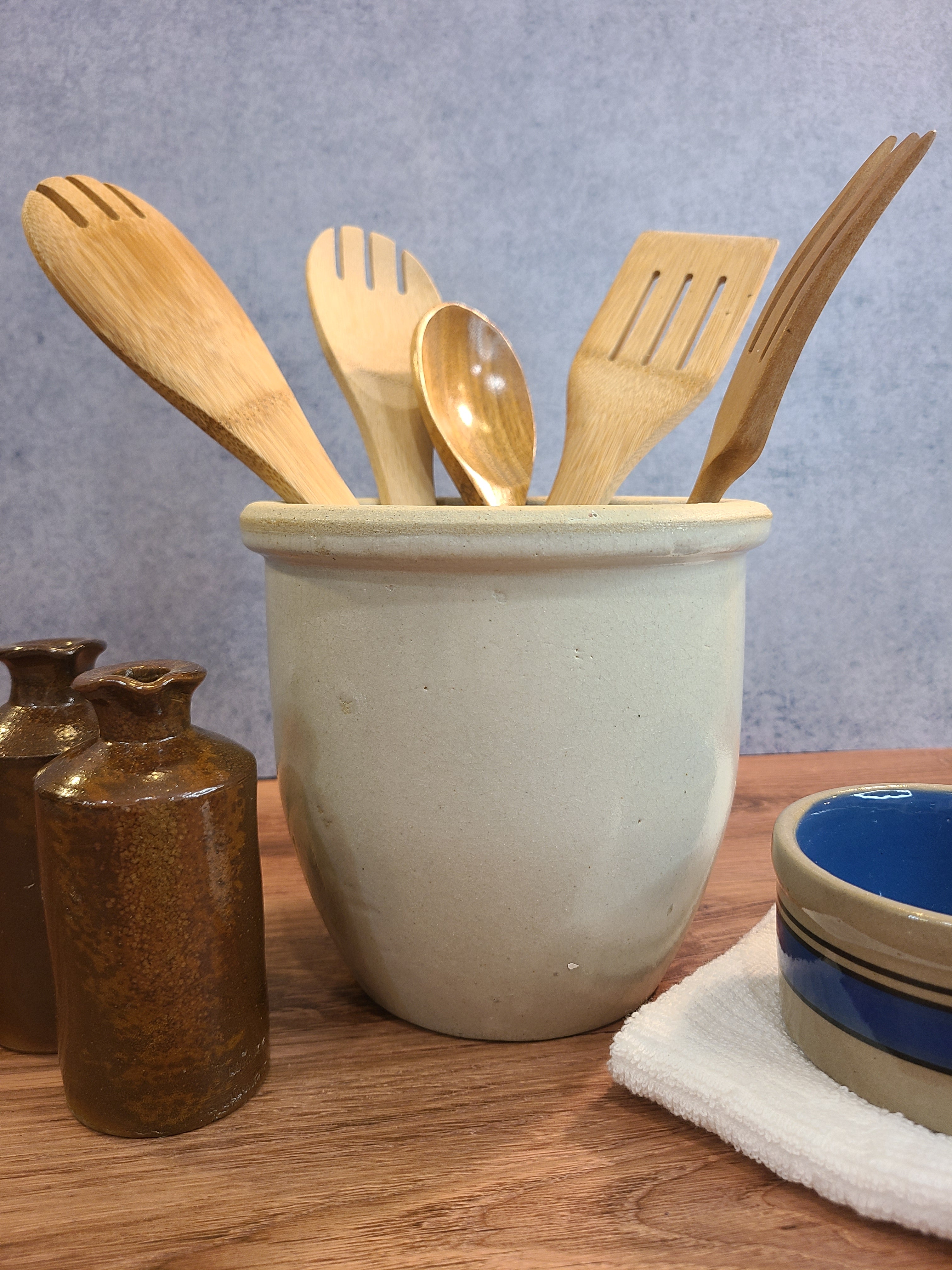 Vintage Handmade White Glazed Crock holding wood kitchen utensils.