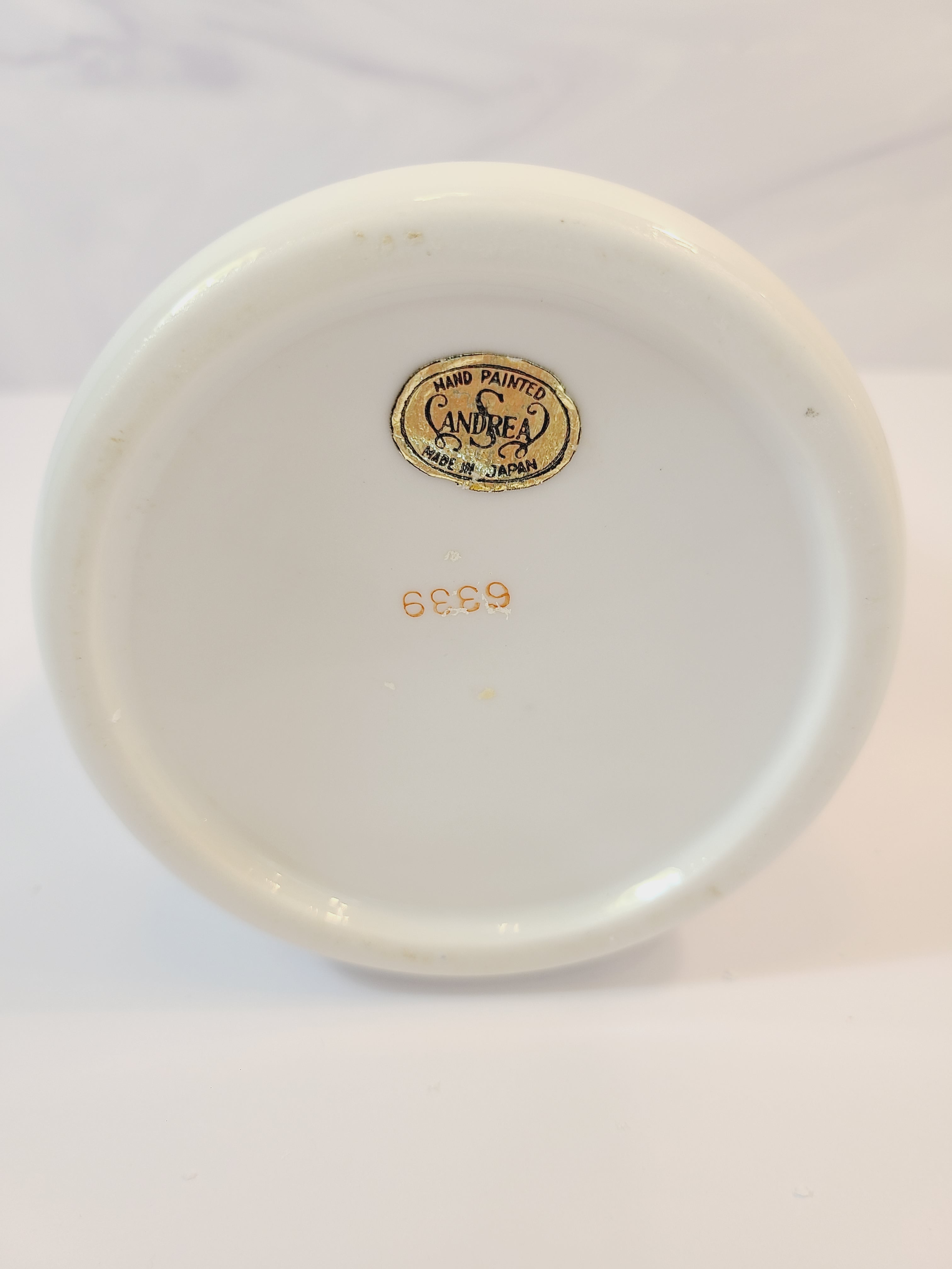 Bottom of Andrea by Sadek vintage white porcelain vase made in Japan hand-painted with light blue floral motifs, gold accents, and a blue-and-gold patterned band at the neck. 