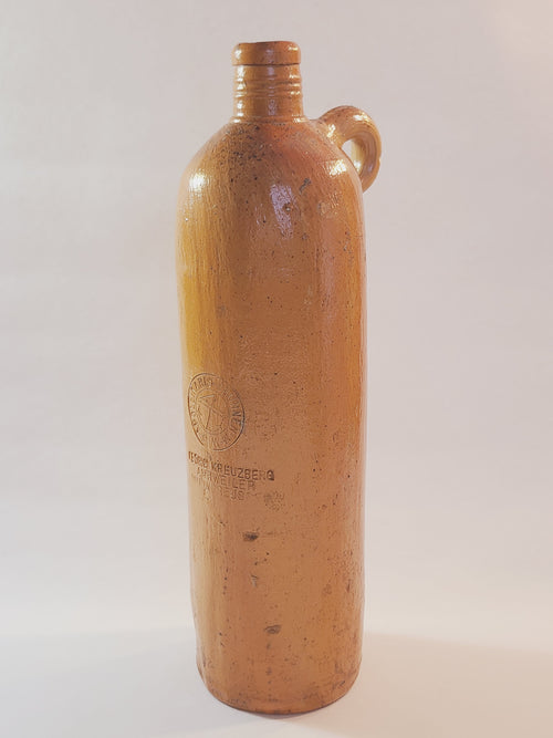 Antique 19th century terracotta colored stoneware bottle stamped with the name of Georg Kreuzberg and the Apollinaris Brunnen.