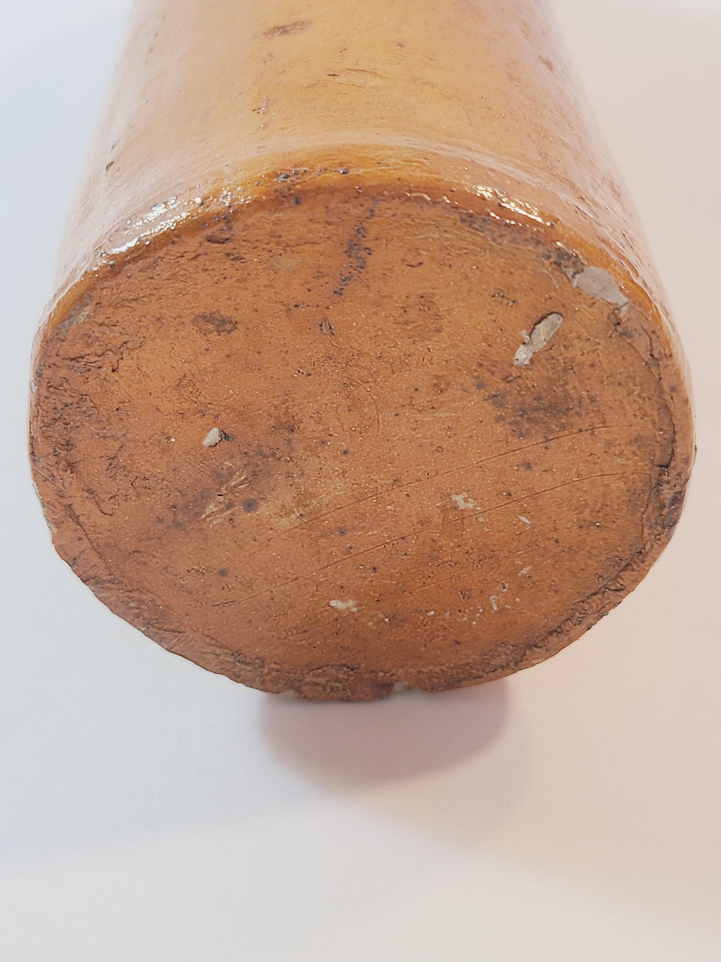 Bottom of Antique 19th century terracotta colored stoneware bottle stamped with the name of Georg Kreuzberg and the Apollinaris Brunnen.