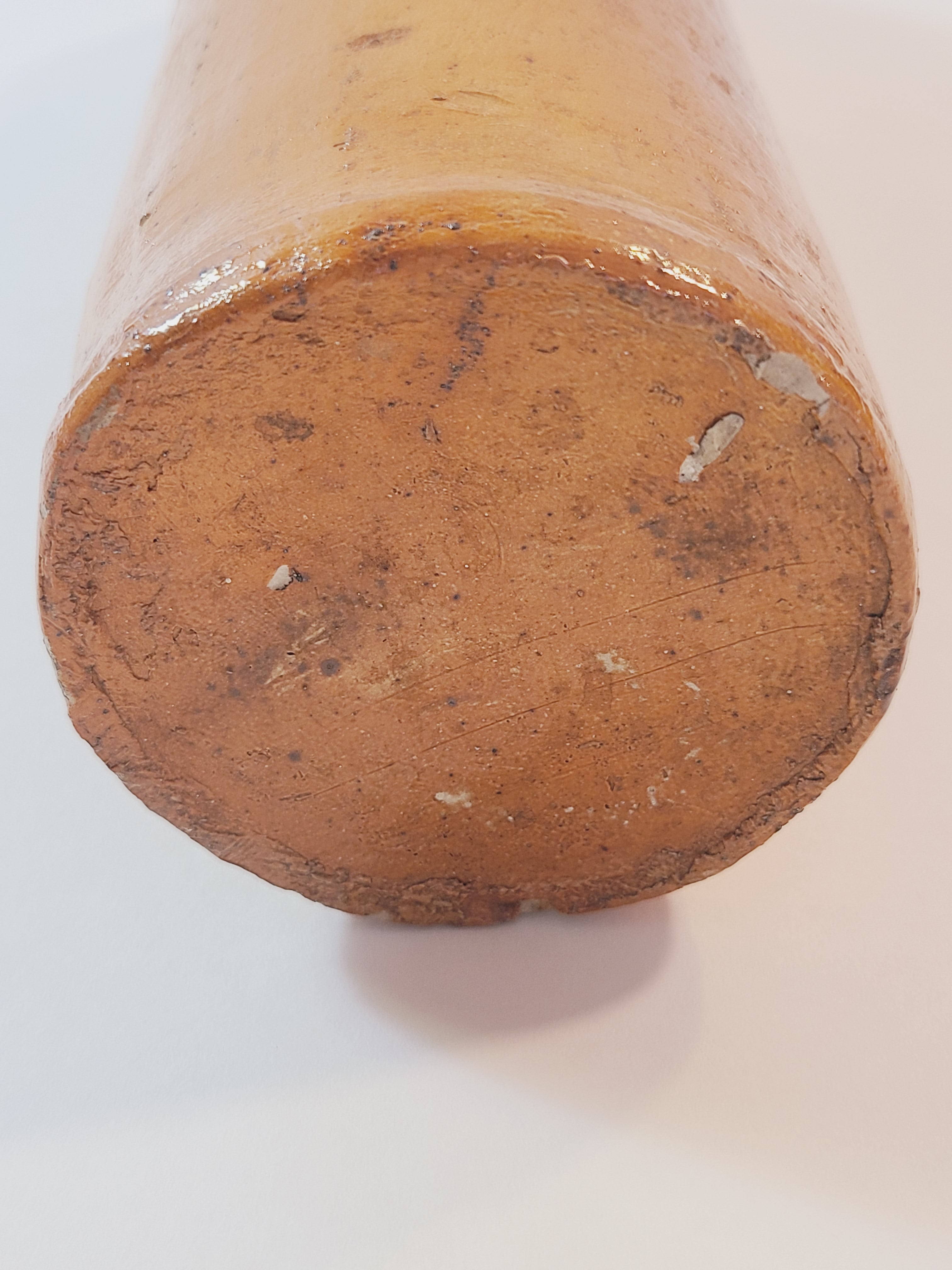 Bottom of Antique 19th century terracotta colored stoneware bottle stamped with the name of Georg Kreuzberg and the Apollinaris Brunnen.