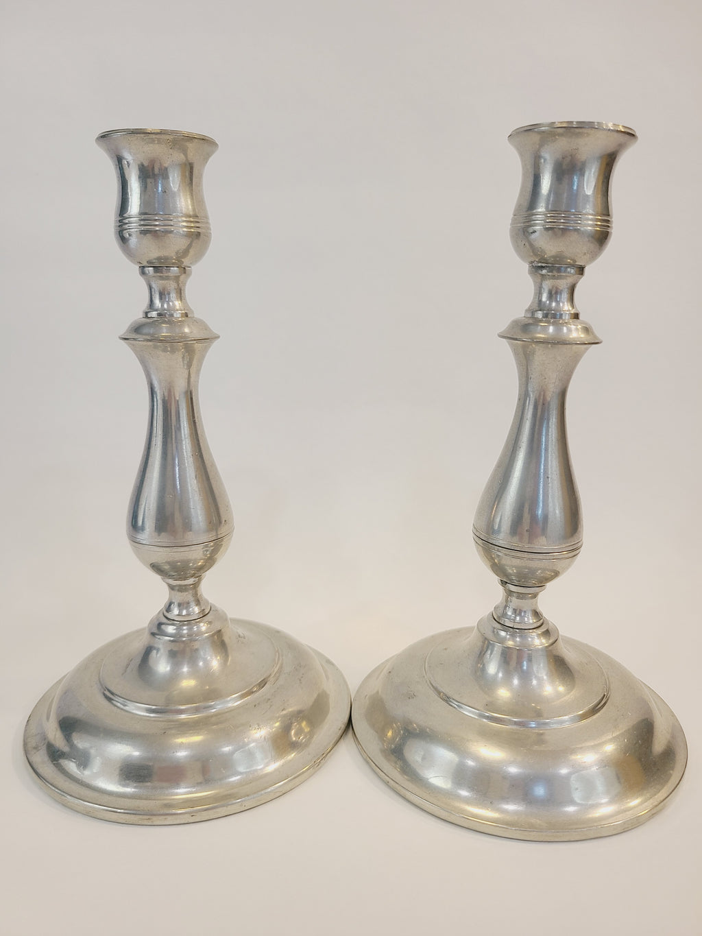 Pair of vintage Stieff Pewter Candlestick holders shown side by side.