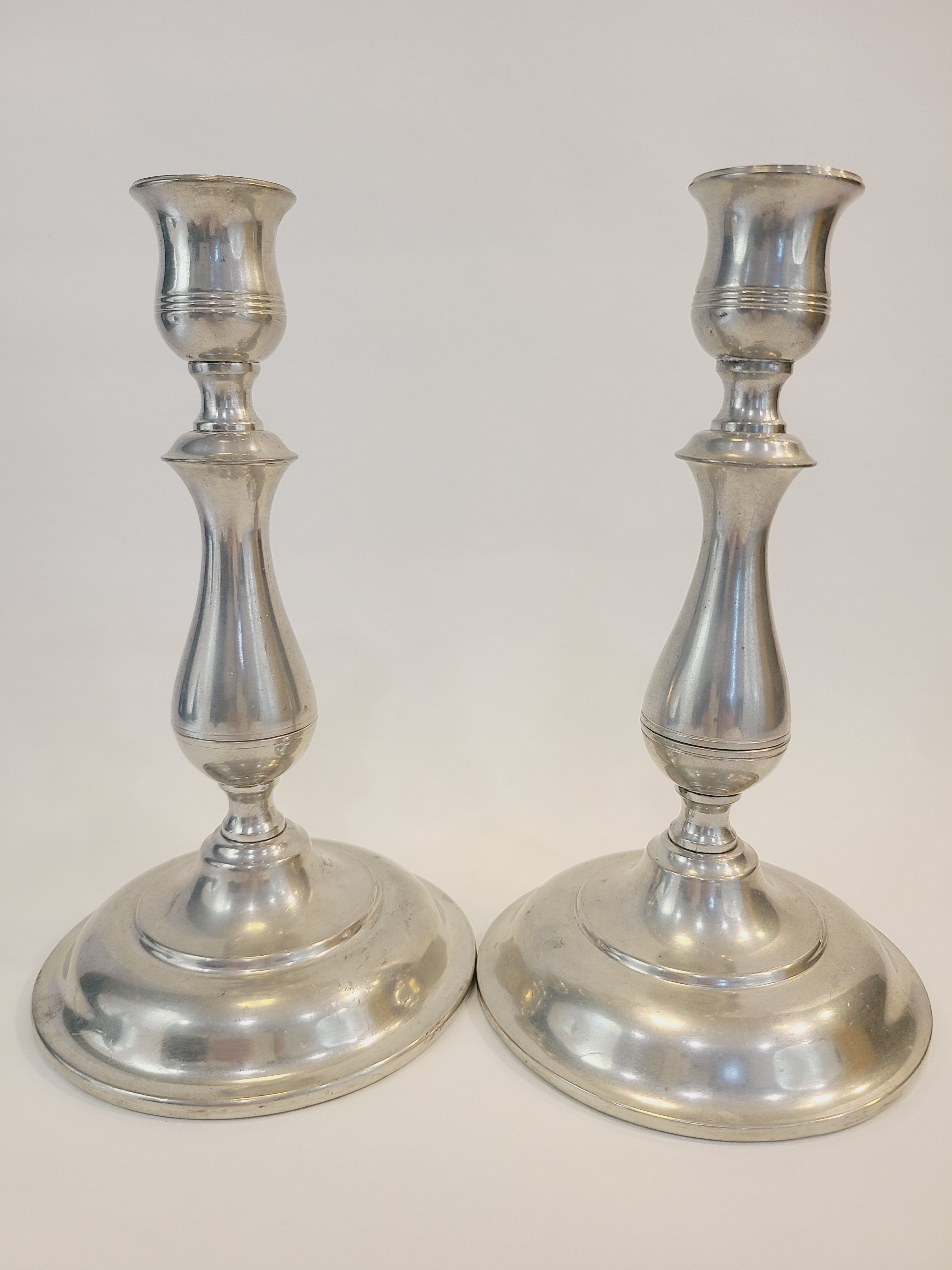 Pair of vintage Stieff Pewter Candlestick holders shown side by side.