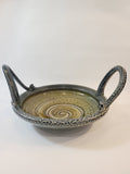 Jon Faulkner studio Pottery Bowl in shades of olive green and darkest blue or black on a white background.