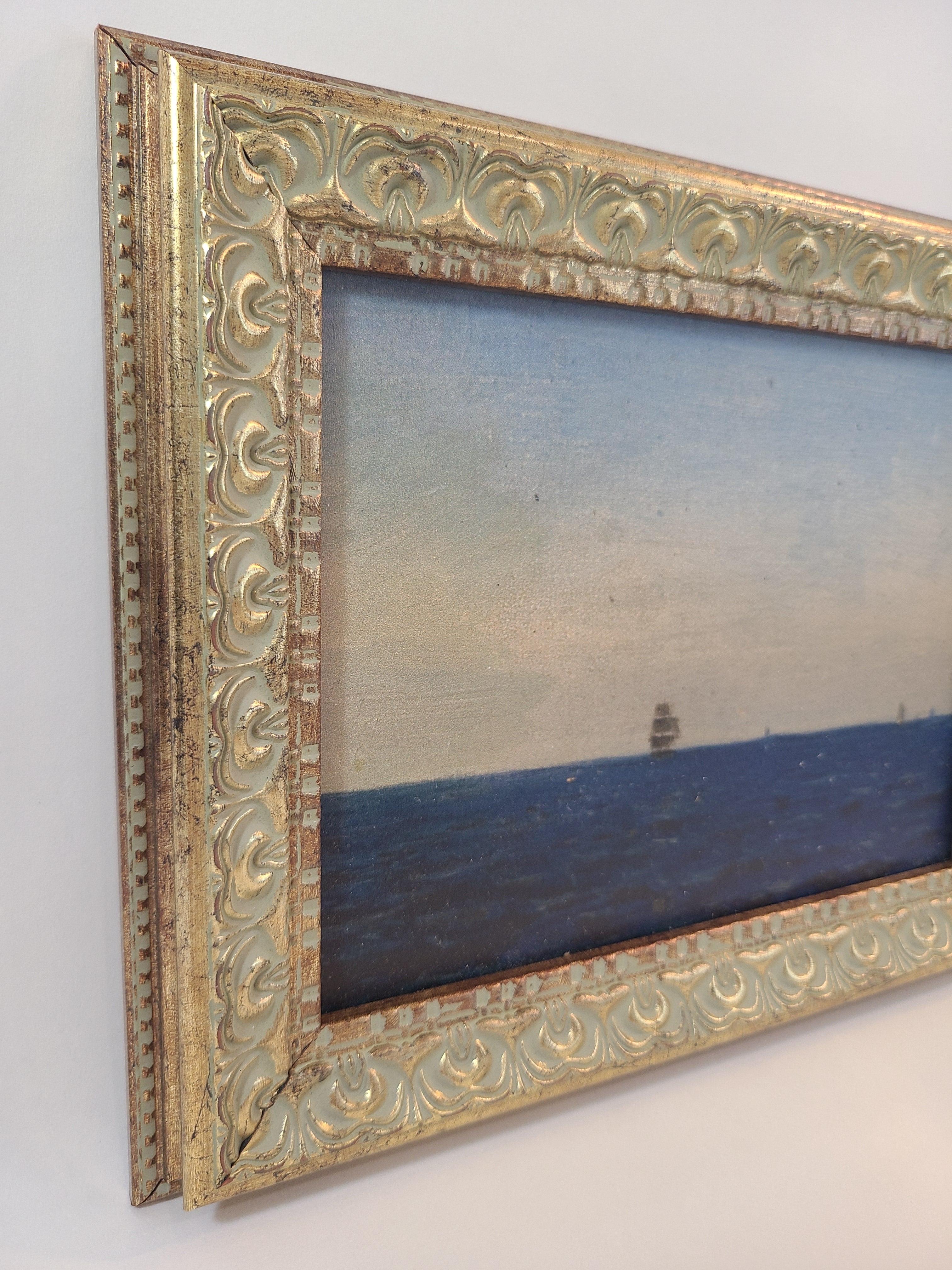 Angled view of Print of the painting Atlanterhavet by Norwegian artist Amaldus Nielsen showing gilded frame.