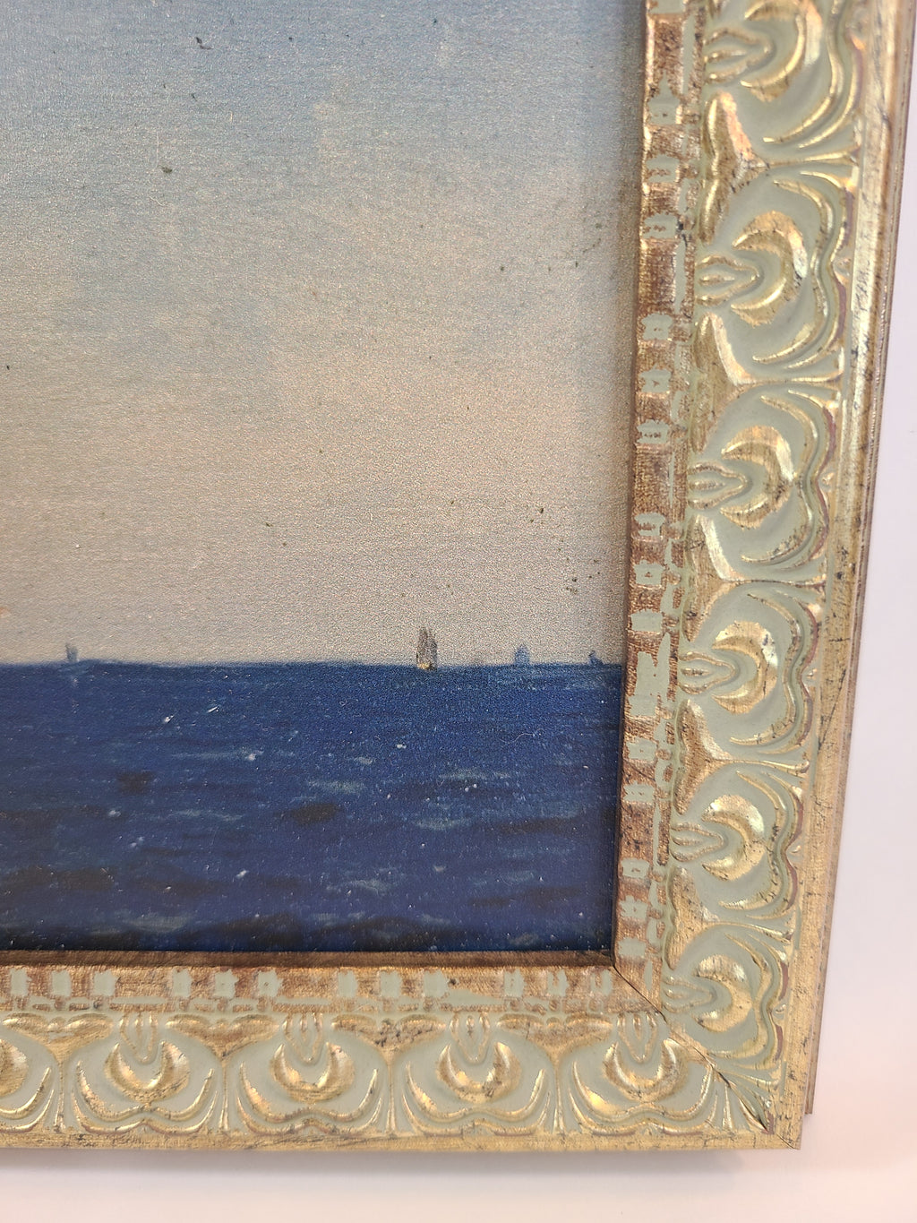 Close up of corner of Print of the painting Atlanterhavet by Norwegian artist Amaldus Nielsen showing intricate frame.