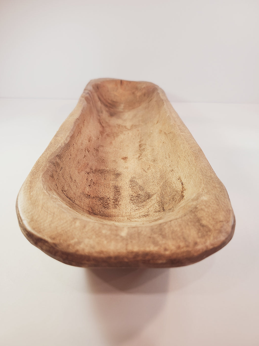 Short end of Oblong vintage Handcrafted Wood Dough Bowl on light background