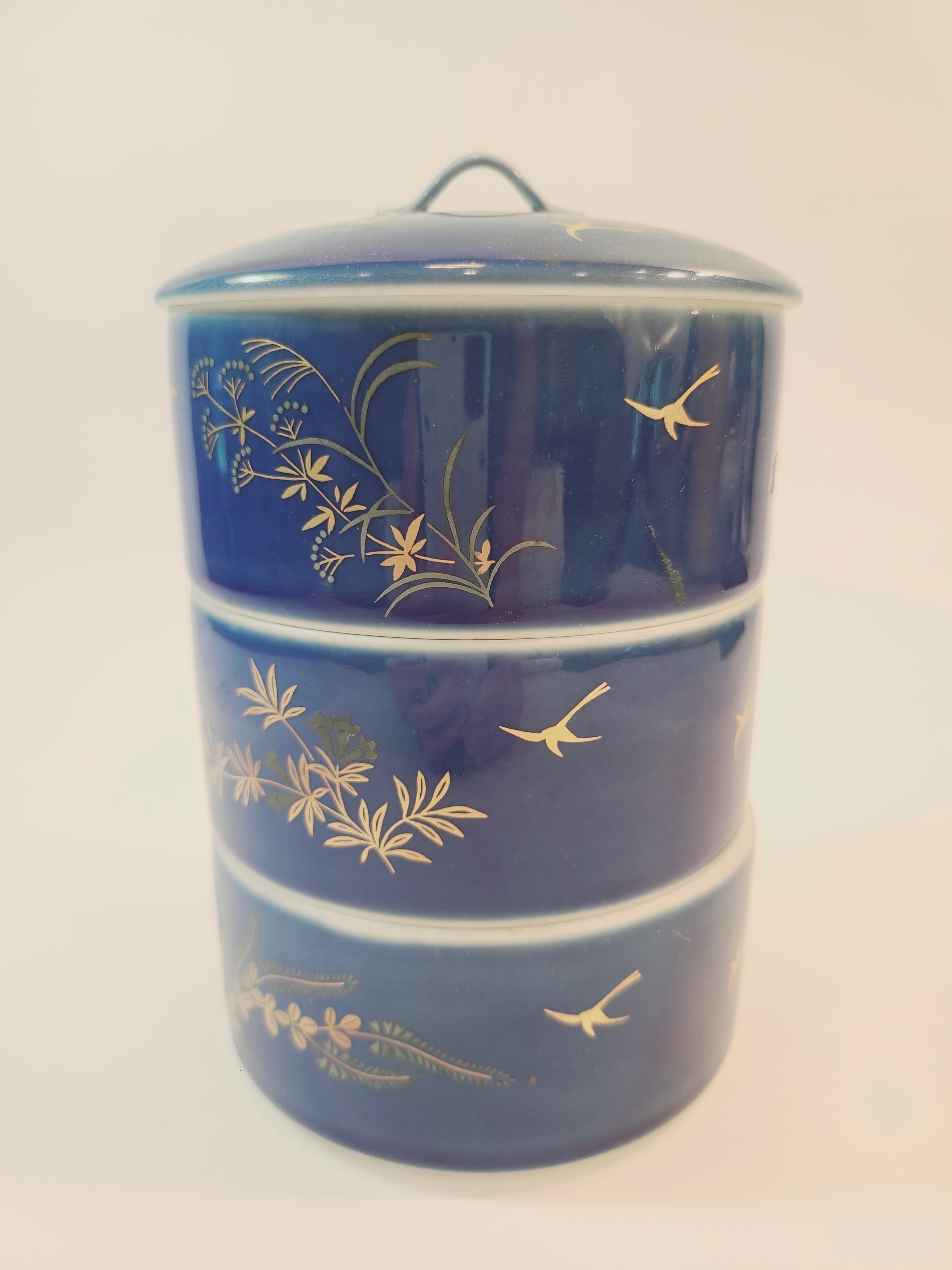 Vintage Fukagawa Seiji 3-Tier Stacking Bowl Set with Lid in lapis blue with gold accents.