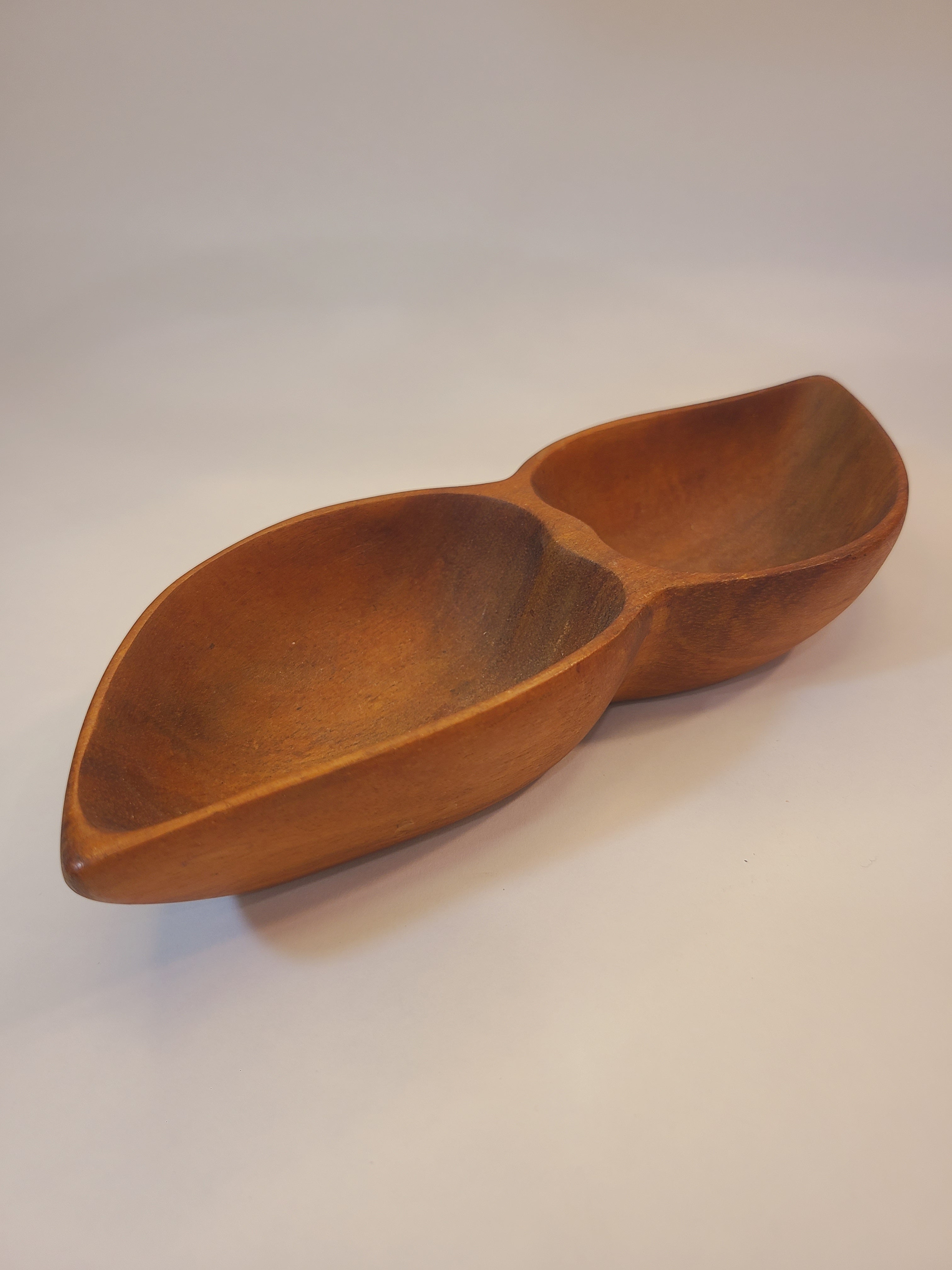 Vintage mid-century wooden bowl with a unique double-compartment leaf design, shown from an angled perspective against a plain off-white background.