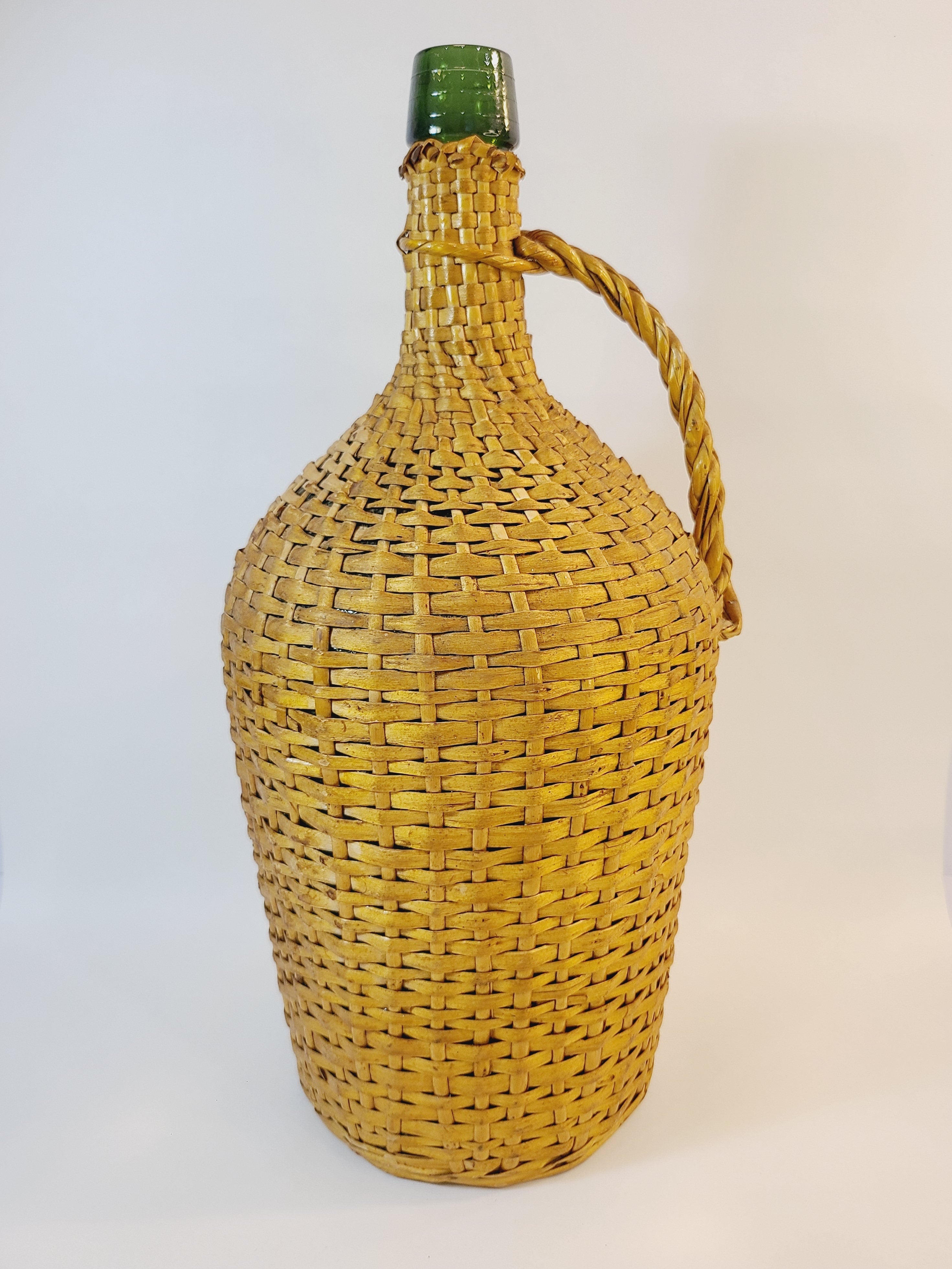 Vintage demijohn green glass with original rattan wrapping.