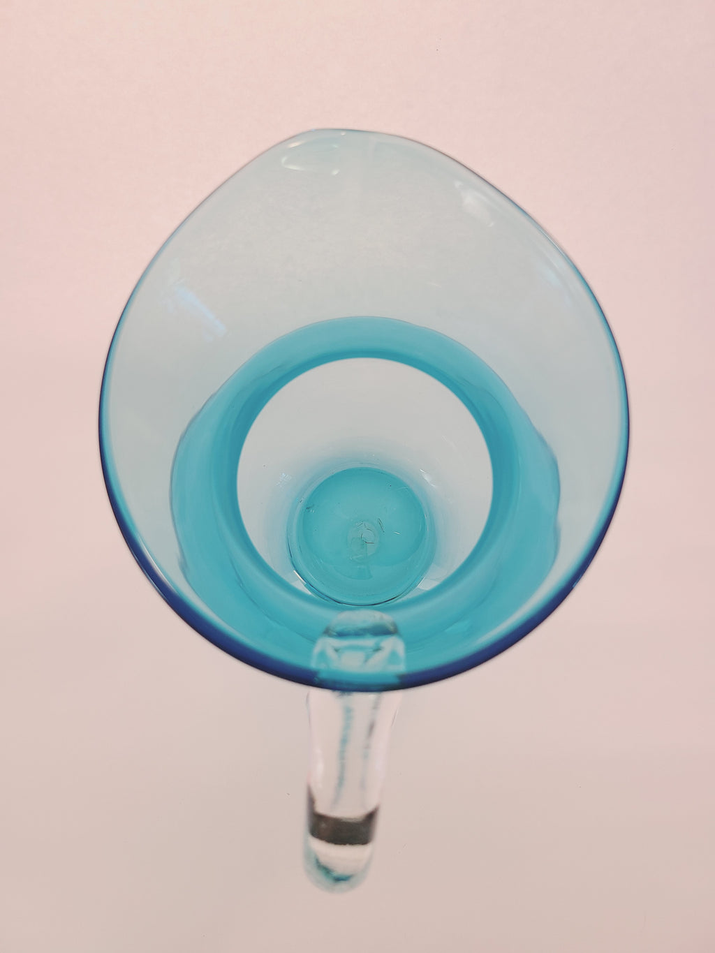 Top view of Turquoise glass vase with clear glass handle.