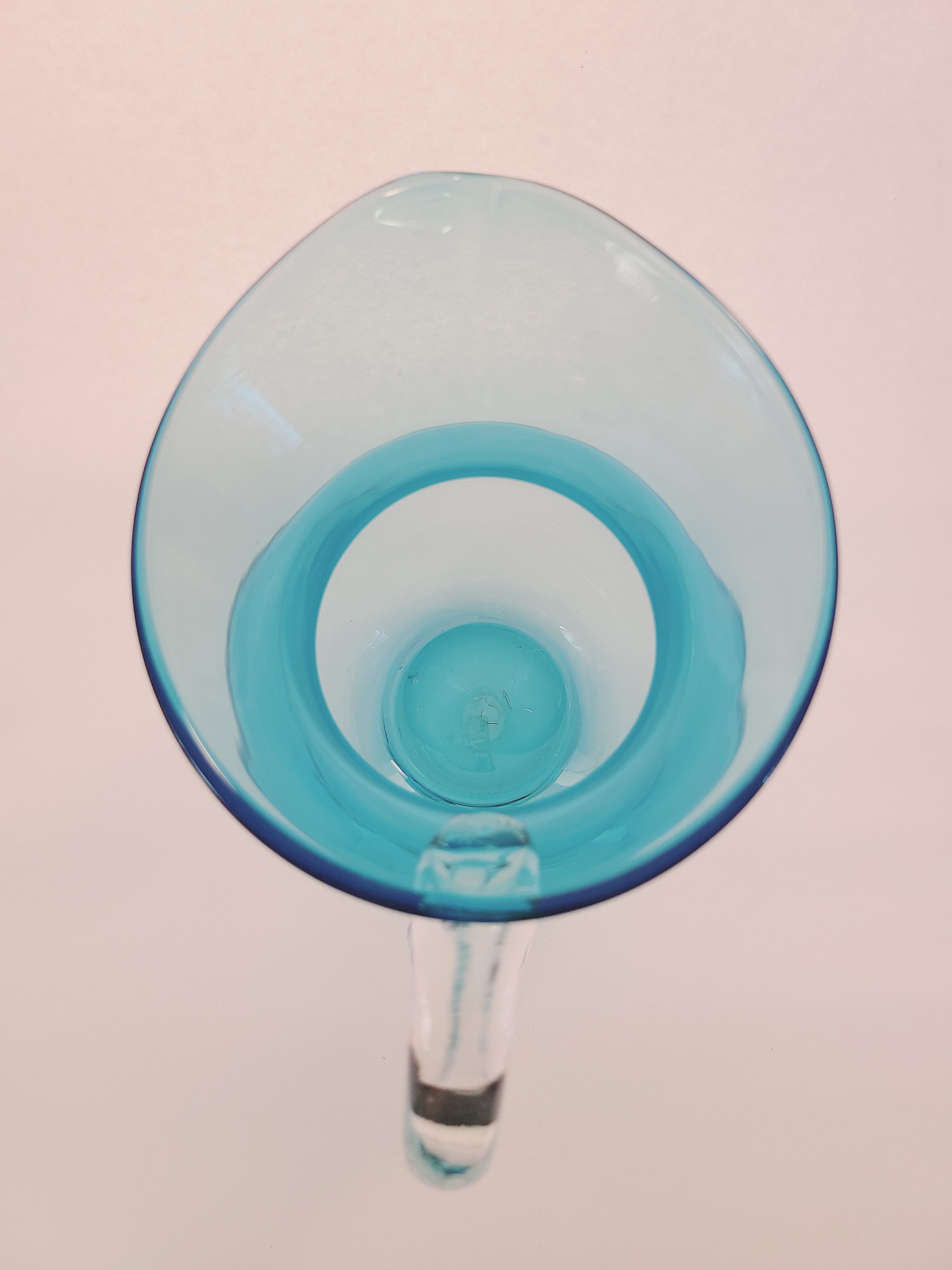 Top view of Turquoise glass vase with clear glass handle.