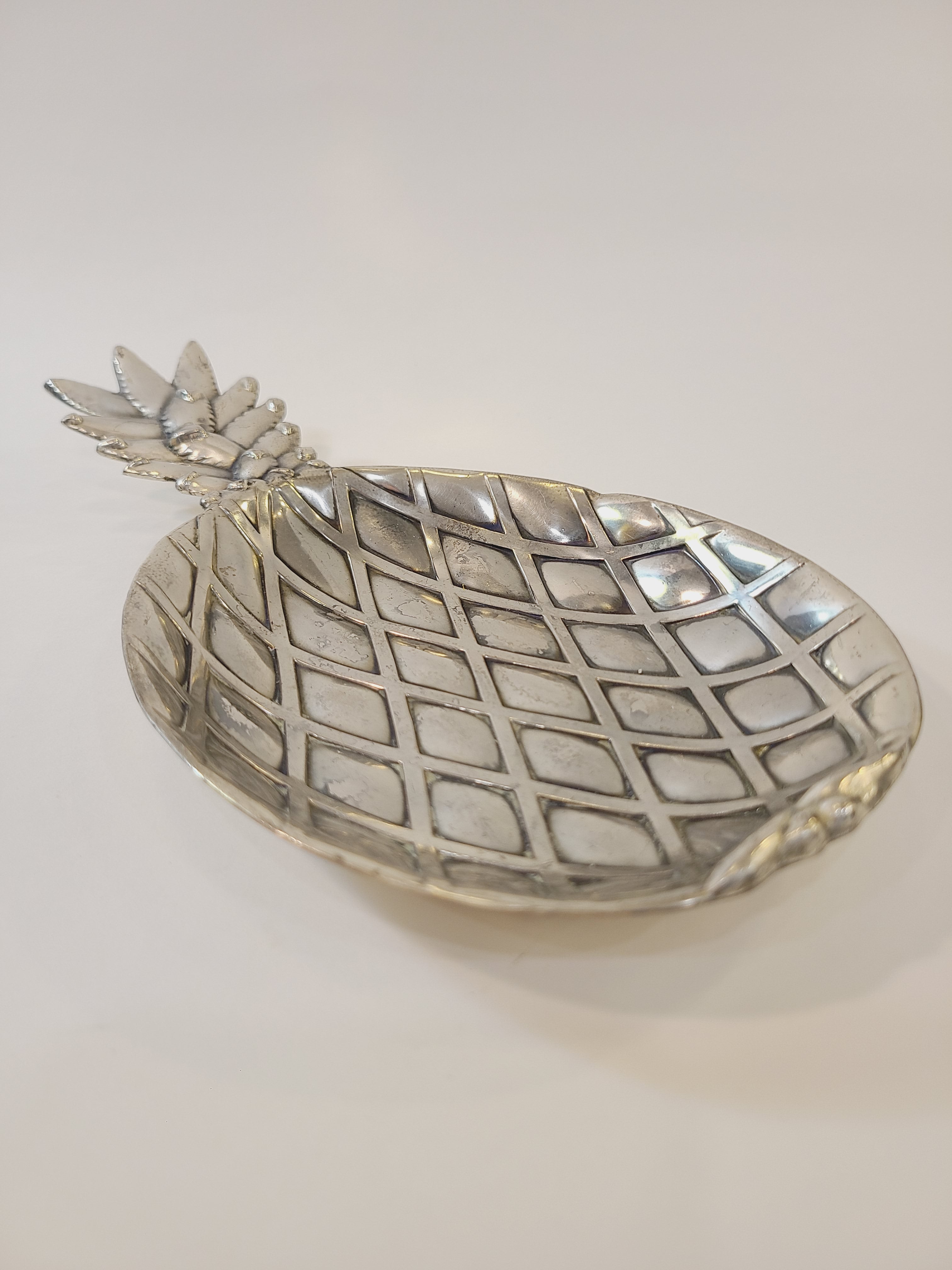 Vintage pineapple silver tone metal dish made in Japan by Matsumoto for the Eleanor retail line photographed to focus on the pineapple body.