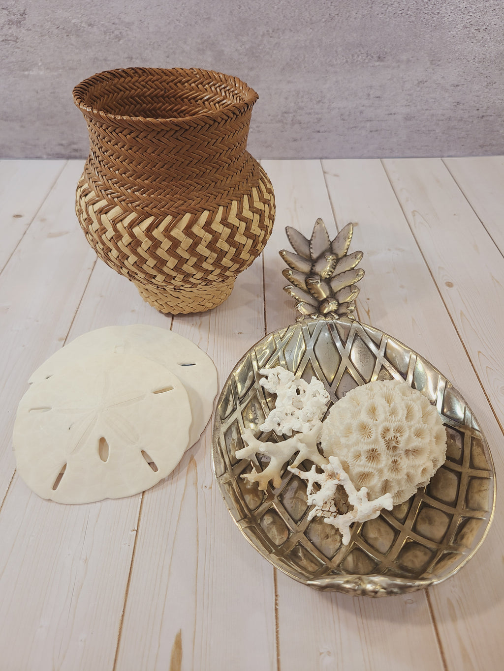 Vintage pineapple silver tone metal dish made in Japan by Matsumoto for the Eleanor retail line displayed with shells and a basket.
