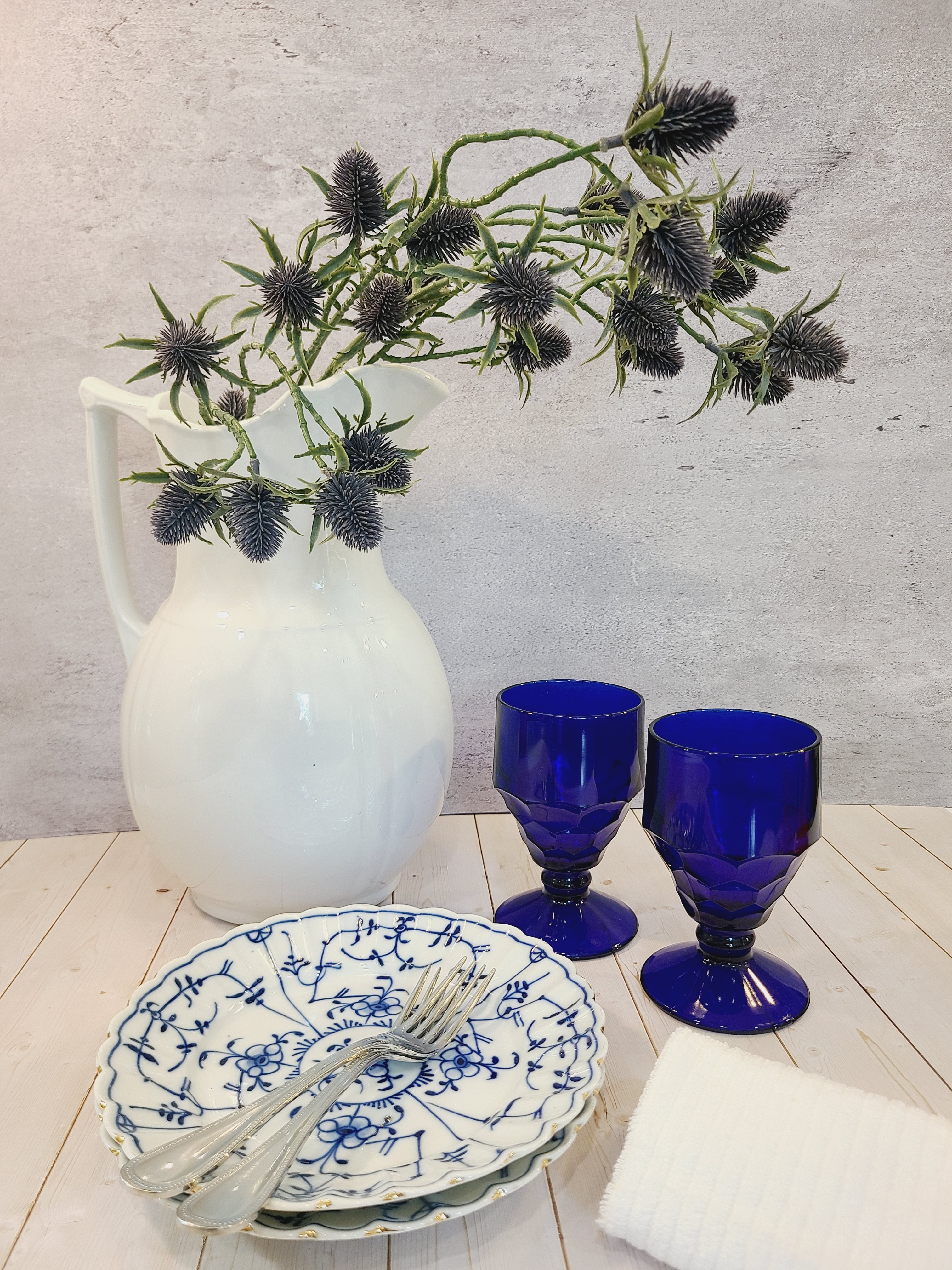 Antique Royal Tettau Blue and White Porcelain Plates displayed with goblets and pitcher.