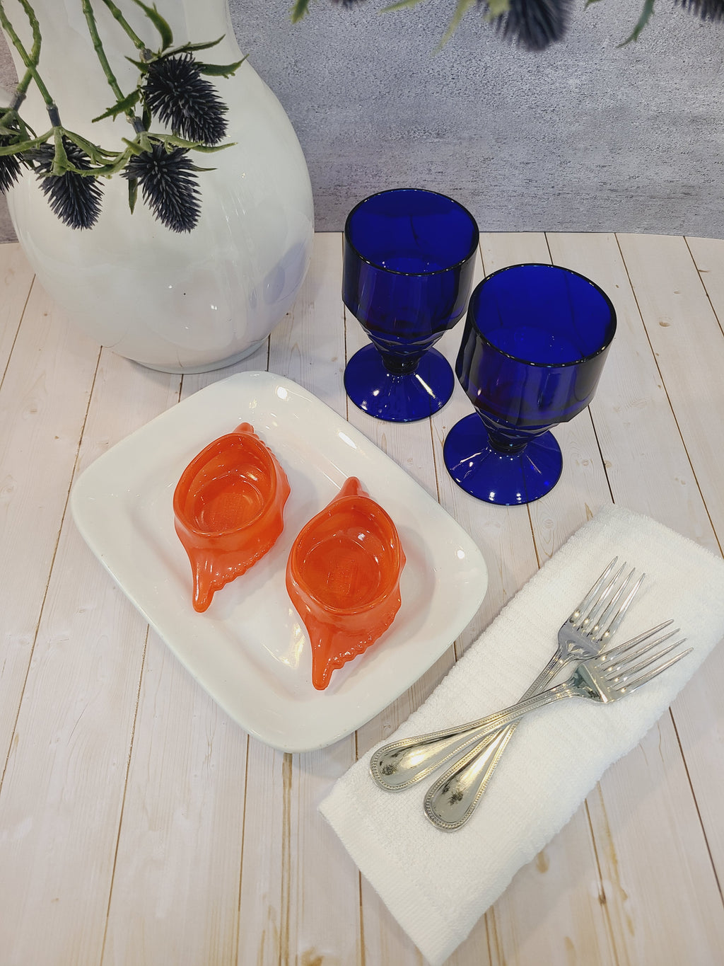 Pair of vintage Viking Glass Georgian Honeycomb Goblets in Cobalt Blue styled with platter holding crab dishes, silverware, ironstone pitcher, linen napkins.