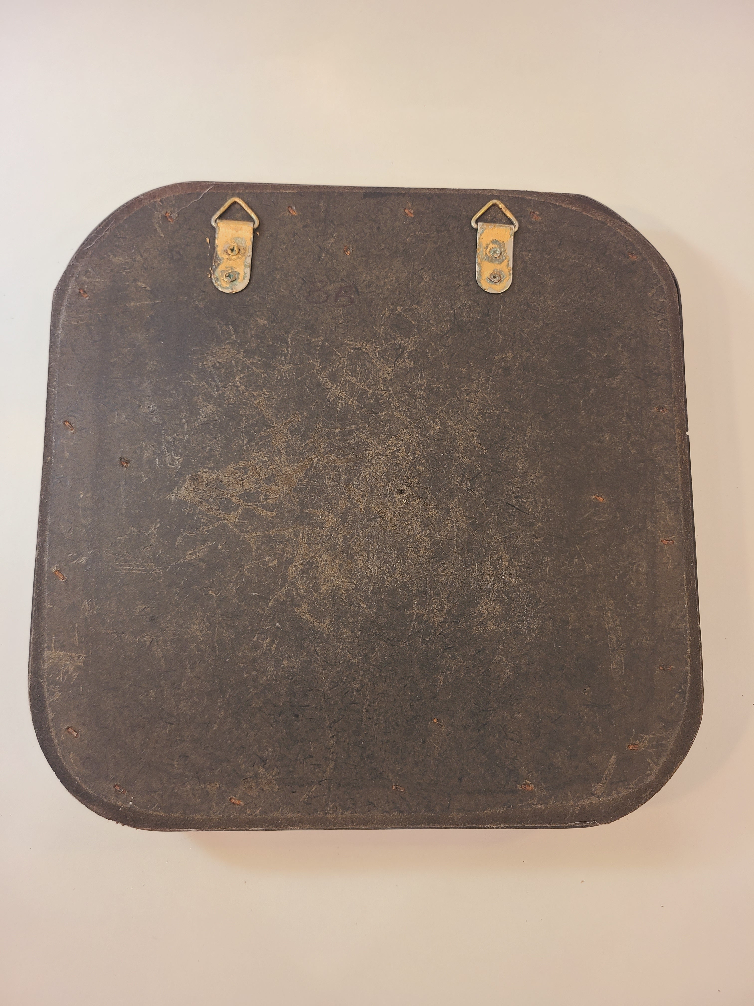 Back of A vintage square decorative wall mirror with an intricately woven dark brown cane frame.