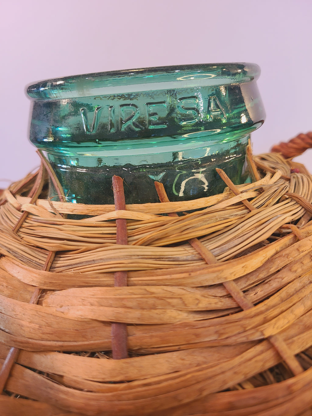 Close up of blue-green Viresa Demijohn with Original Rattan circa 1960s 15 inch showing the embossed Viresa name.