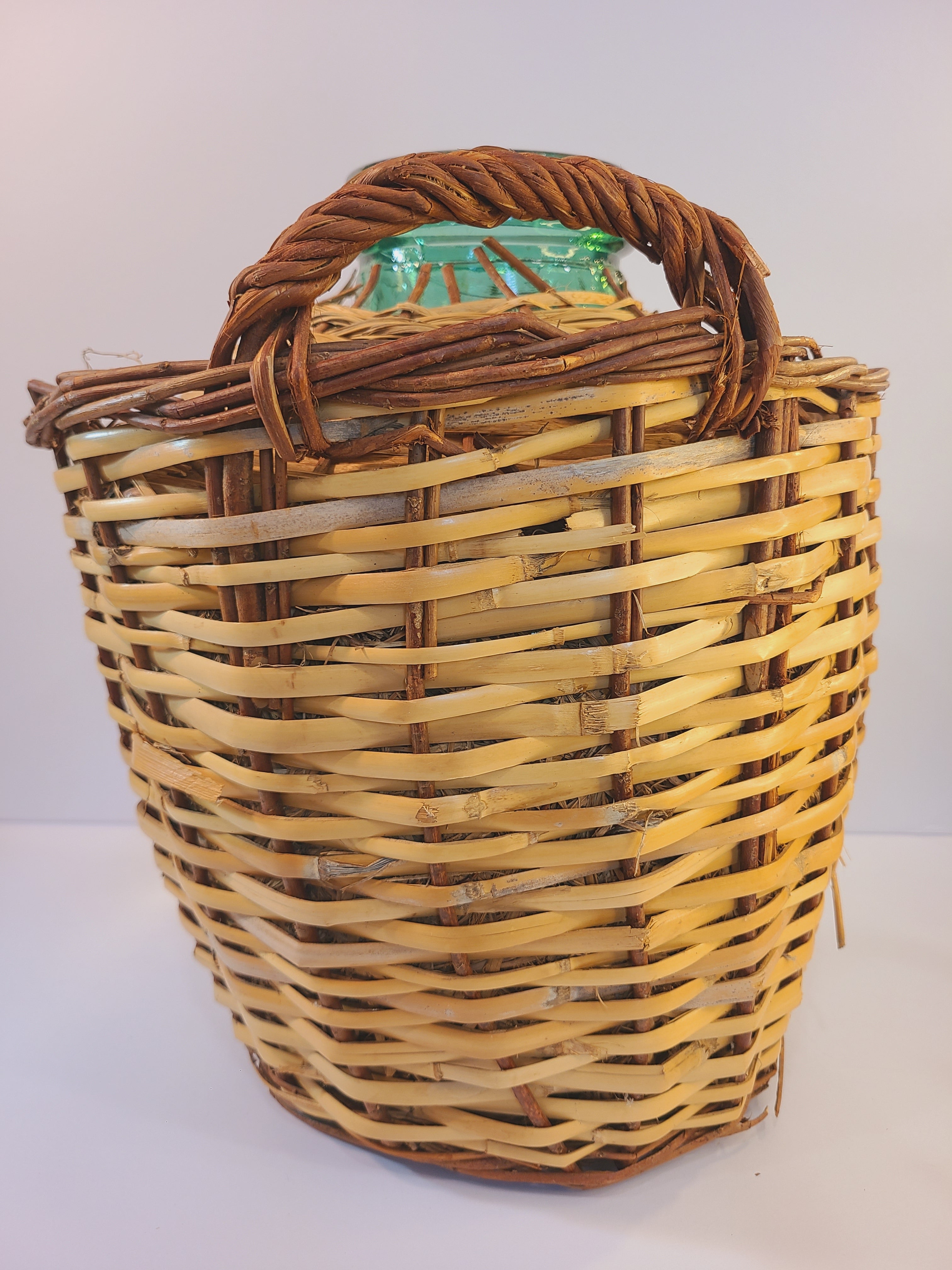 SIde view of blue-green Viresa Demijohn with Original Rattan circa 1960s 15 inch