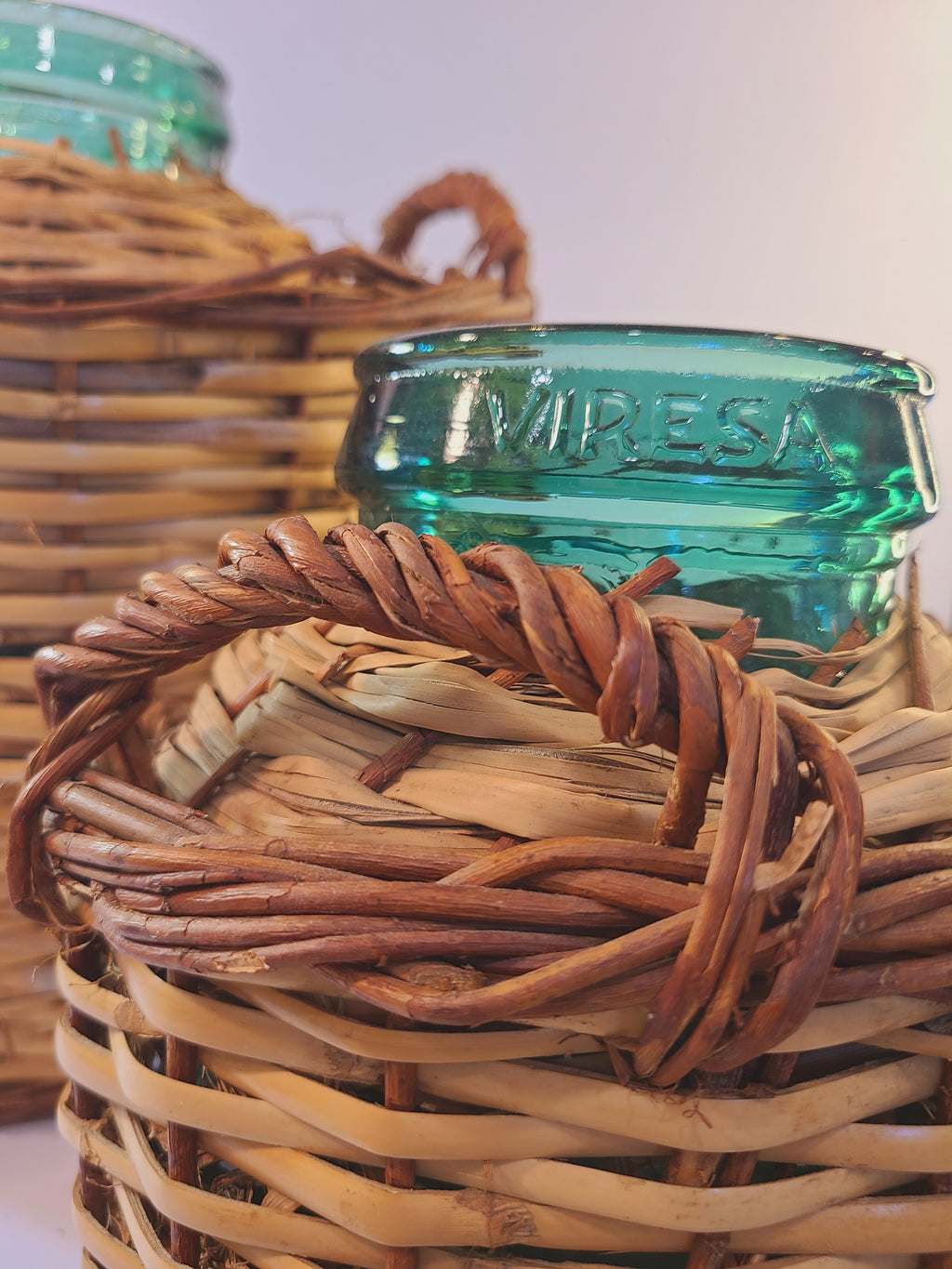 Close up of Vintage blue-green Viresa Demijohn with Original Rattan circa 1960s 10.5 inches showing Viresa name
