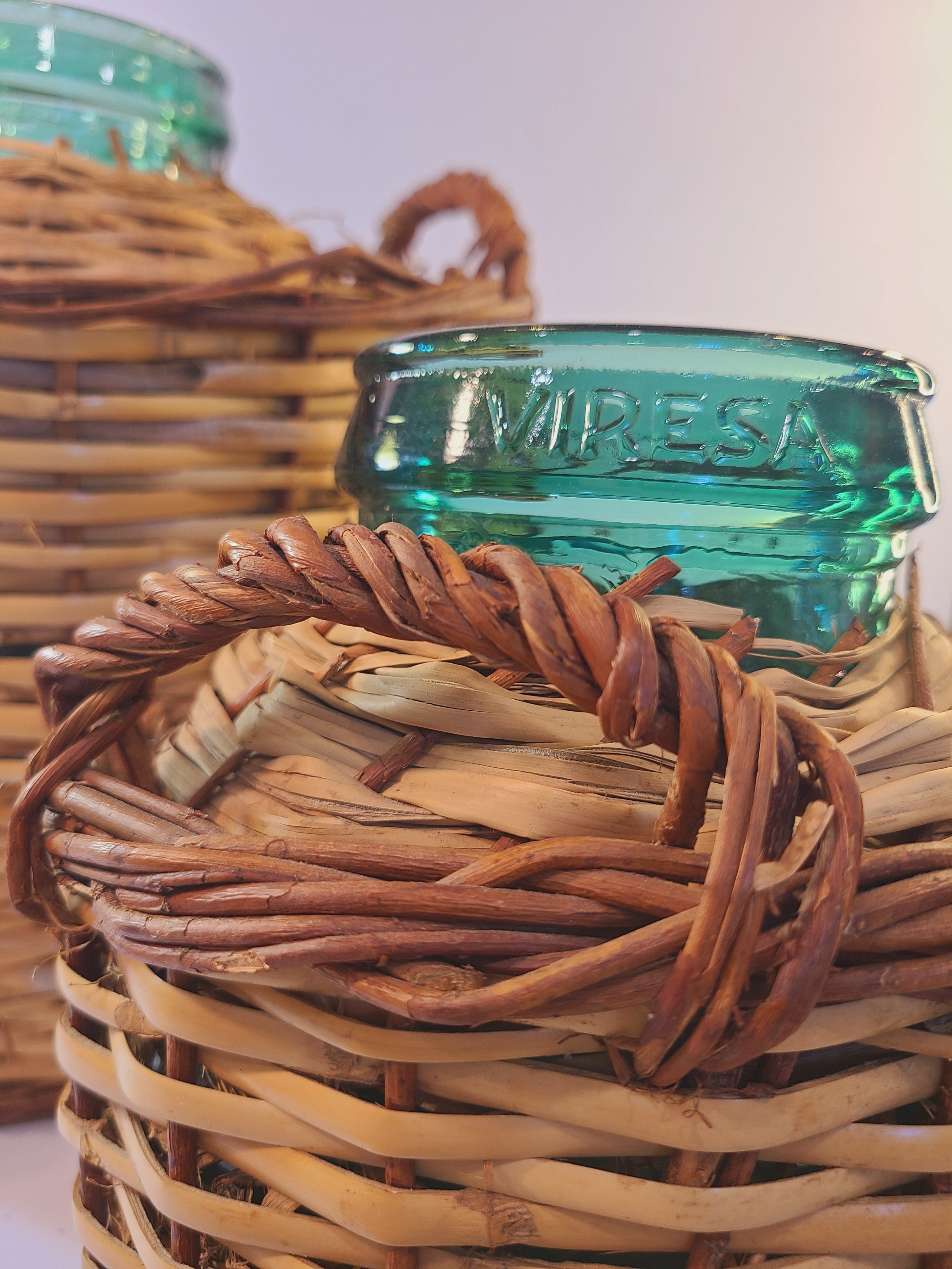 Close up of Vintage blue-green Viresa Demijohn with Original Rattan circa 1960s 10.5 inches showing Viresa name