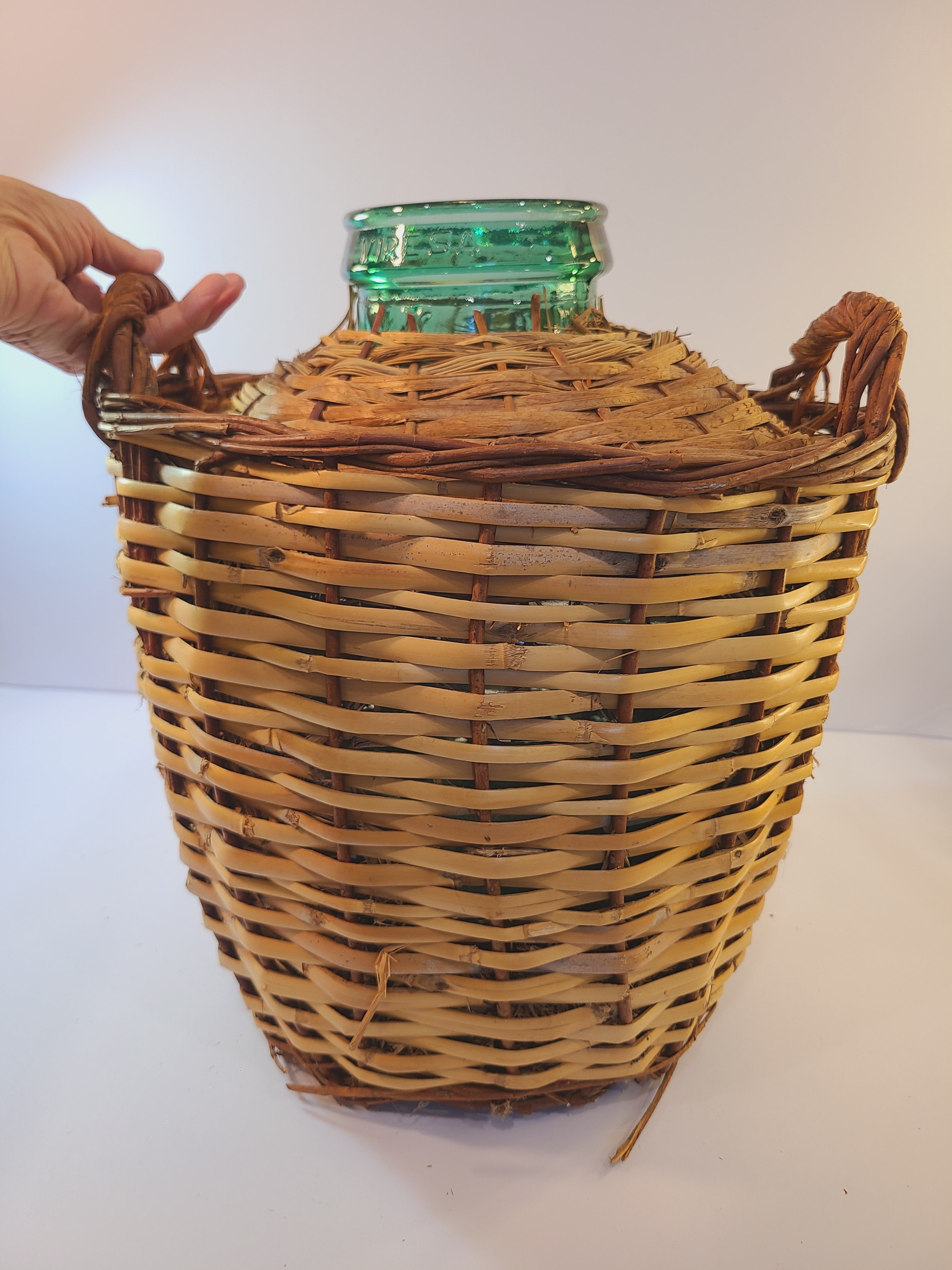 Viresa blue-green Demijohn with Original Rattan circa 1960s 15 inch photographed with person's hand to show size.