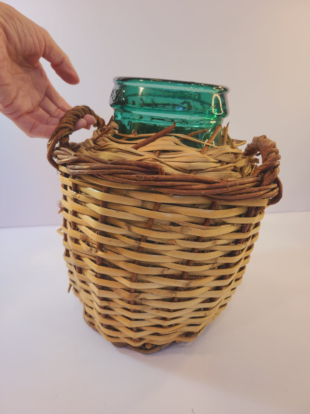Vintage blue-green Viresa Demijohn with Original Rattan circa 1960s 10.5 inches with person's hand to show size