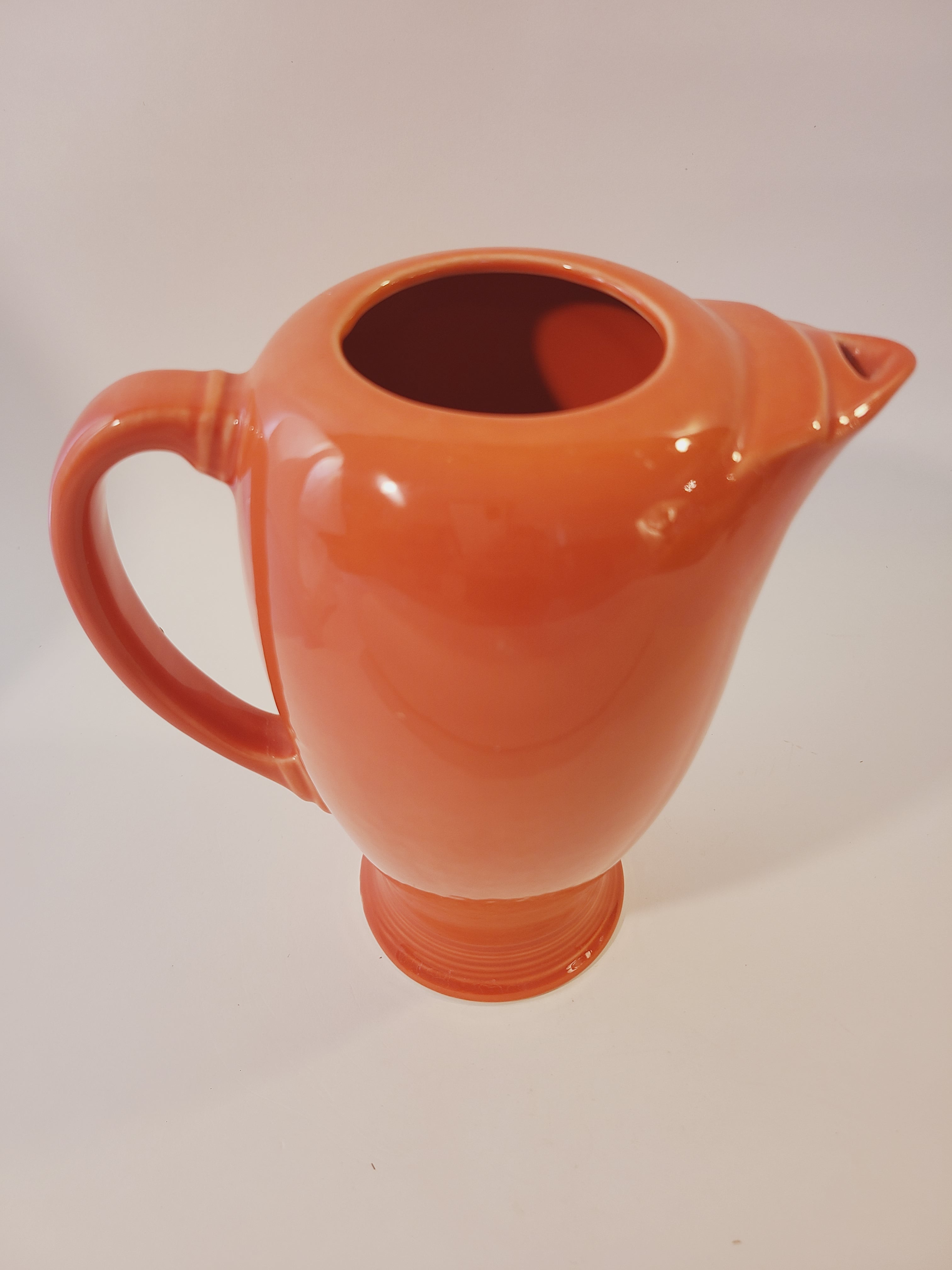 Top view of Fiesta carafe in color Persimmon set against plain white background.