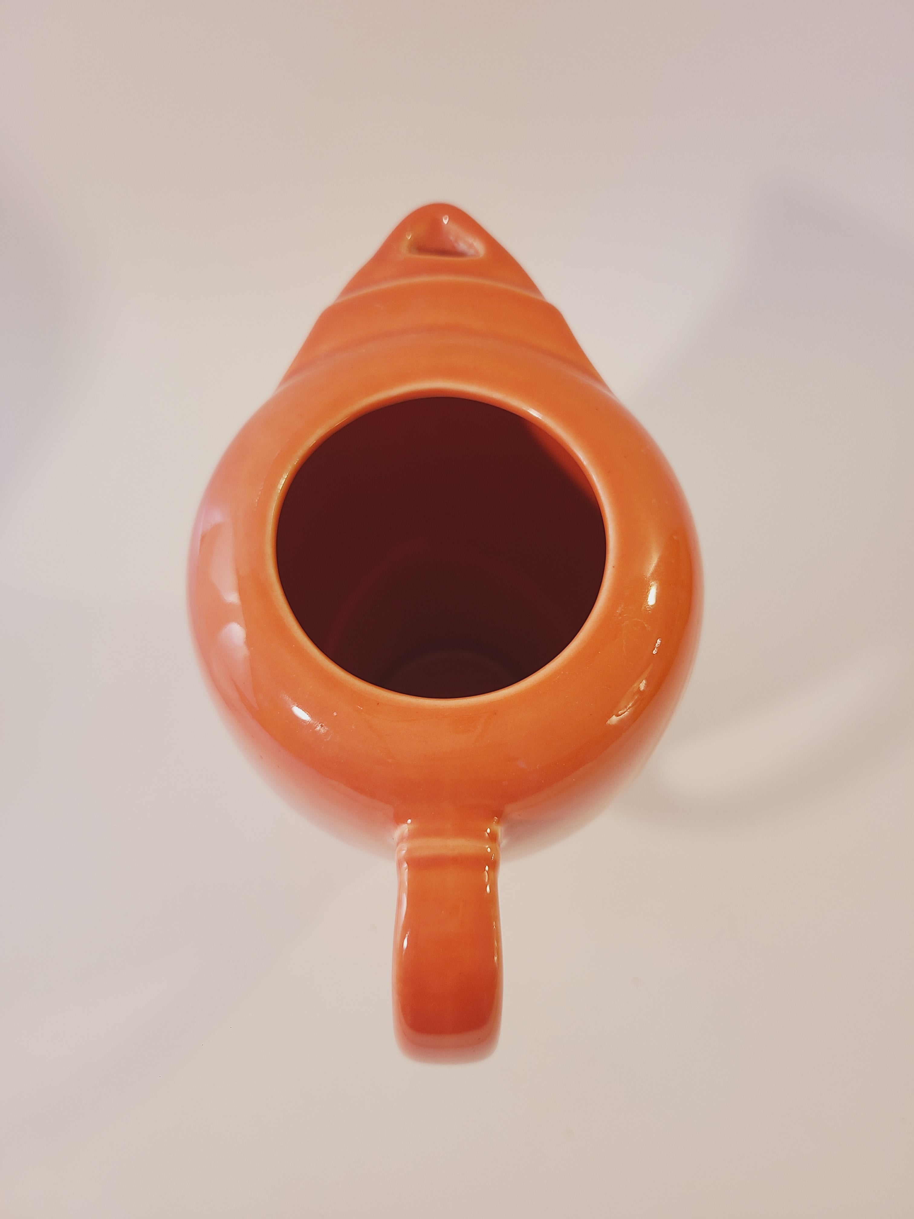 Fiesta carafe in color Persimmon set photographed from above.