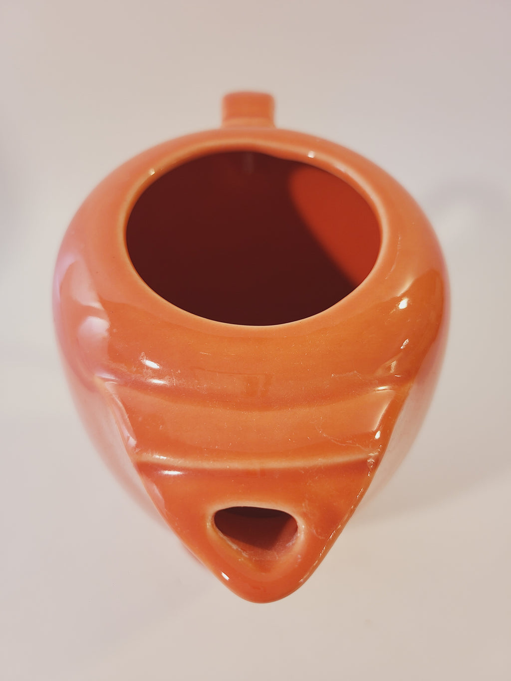 Close up of top view of Fiesta carafe in color Persimmon set against plain white background.