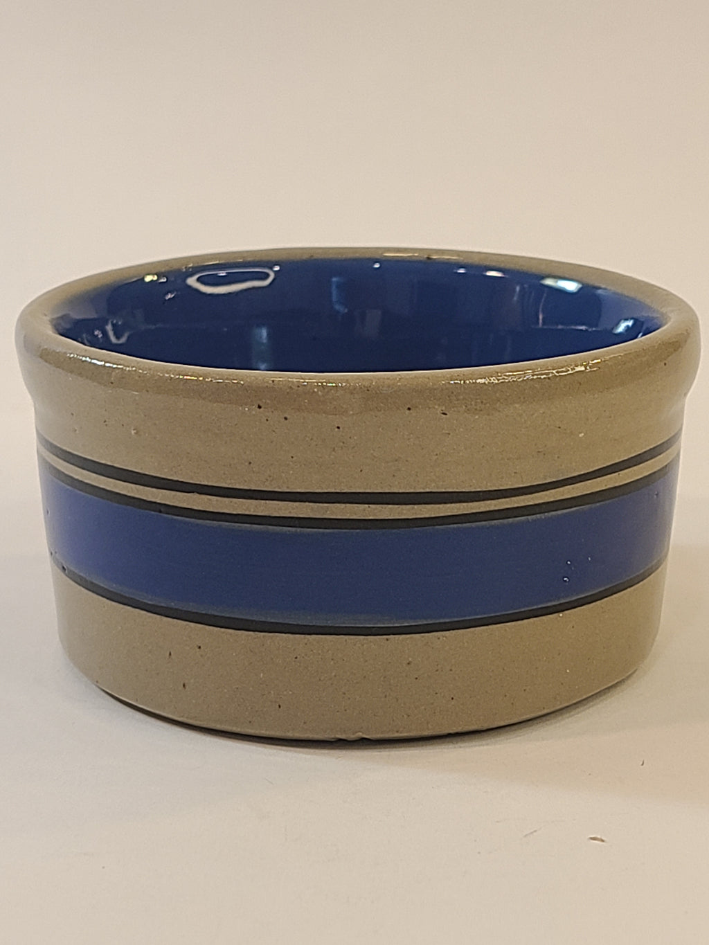 Petite vintage gray crock with blue stripes viewed from the side.