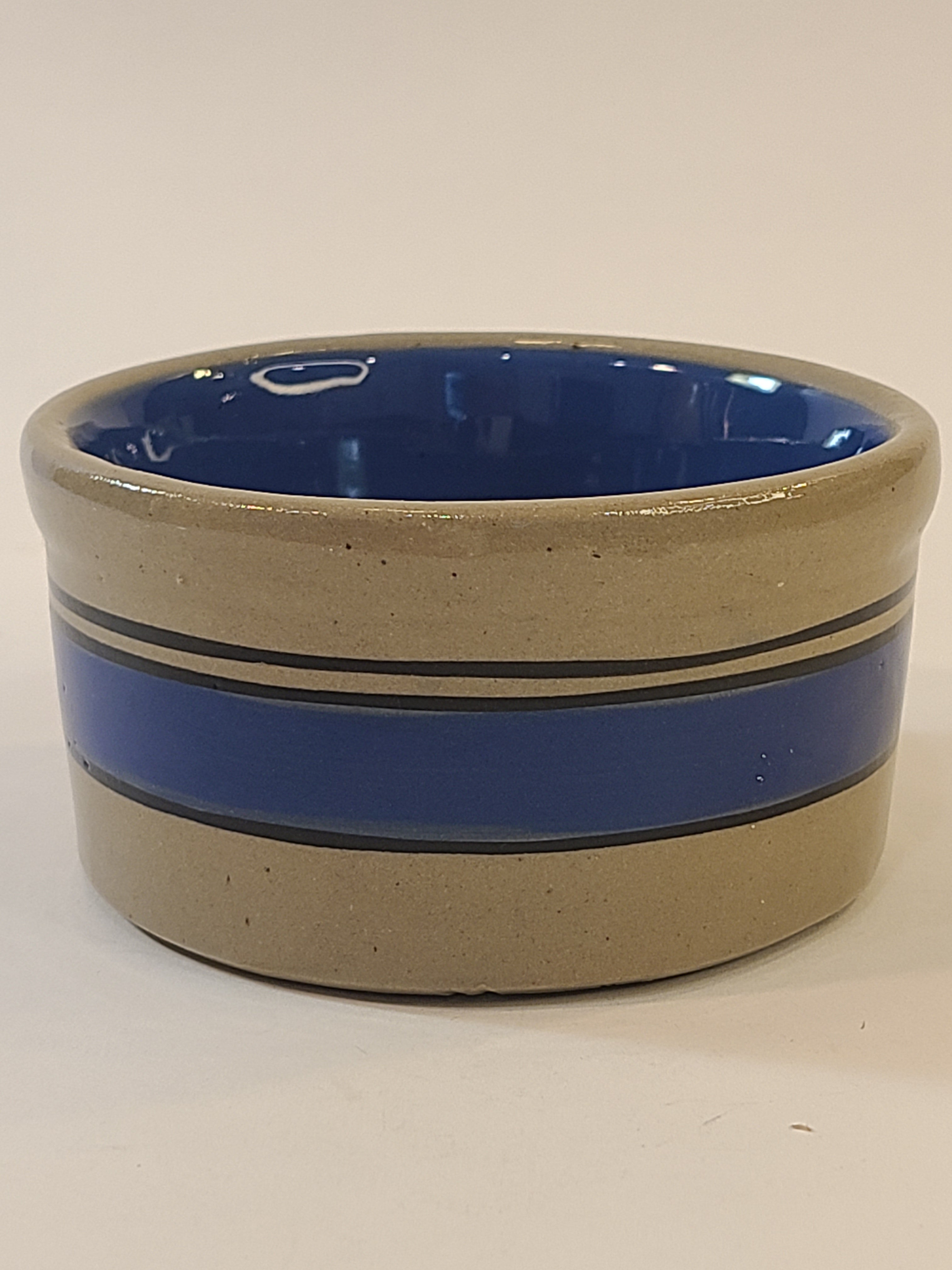 Petite vintage gray crock with blue stripes viewed from the side.