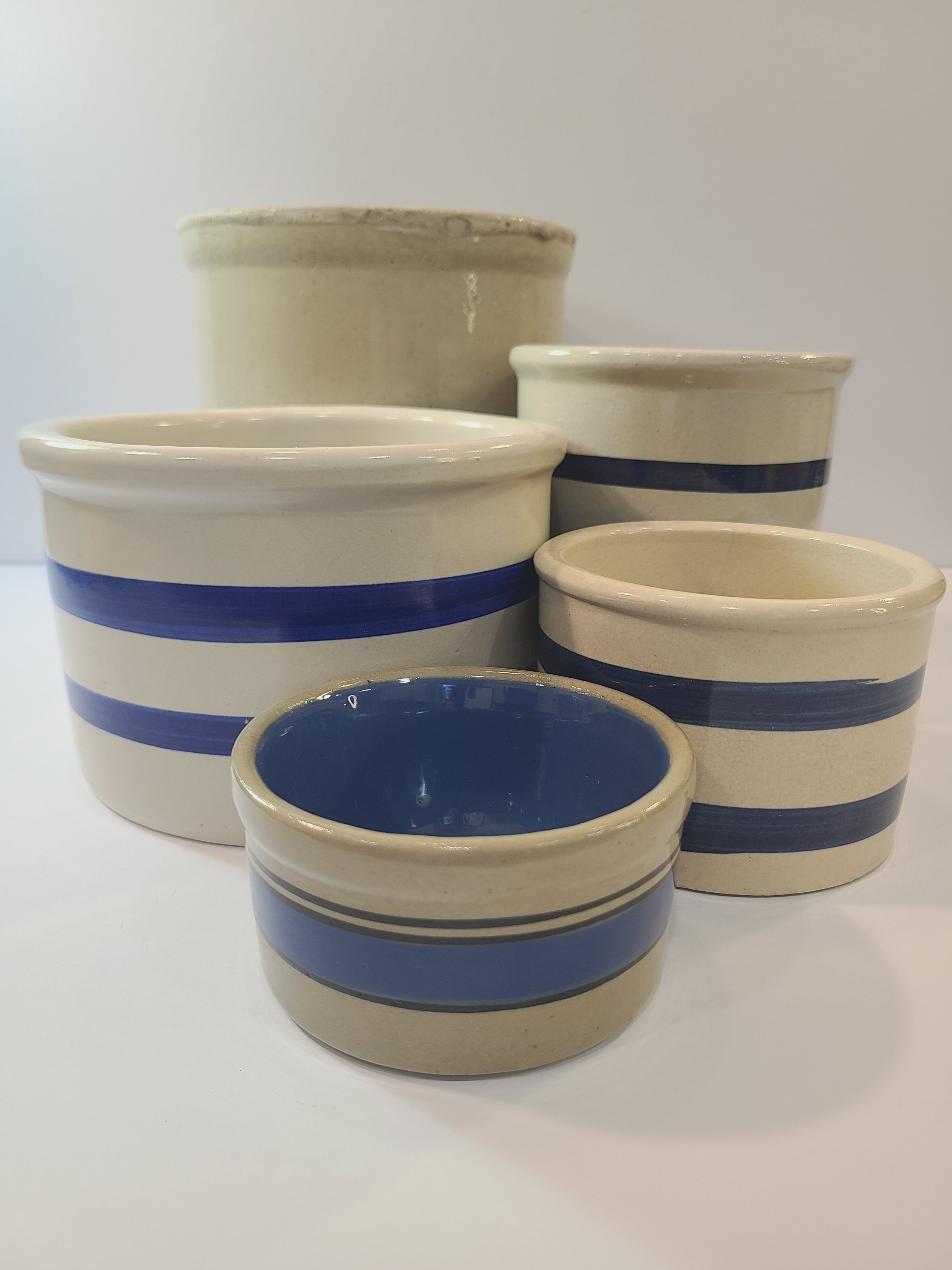 Collection of vintage blue and off-white crocks.