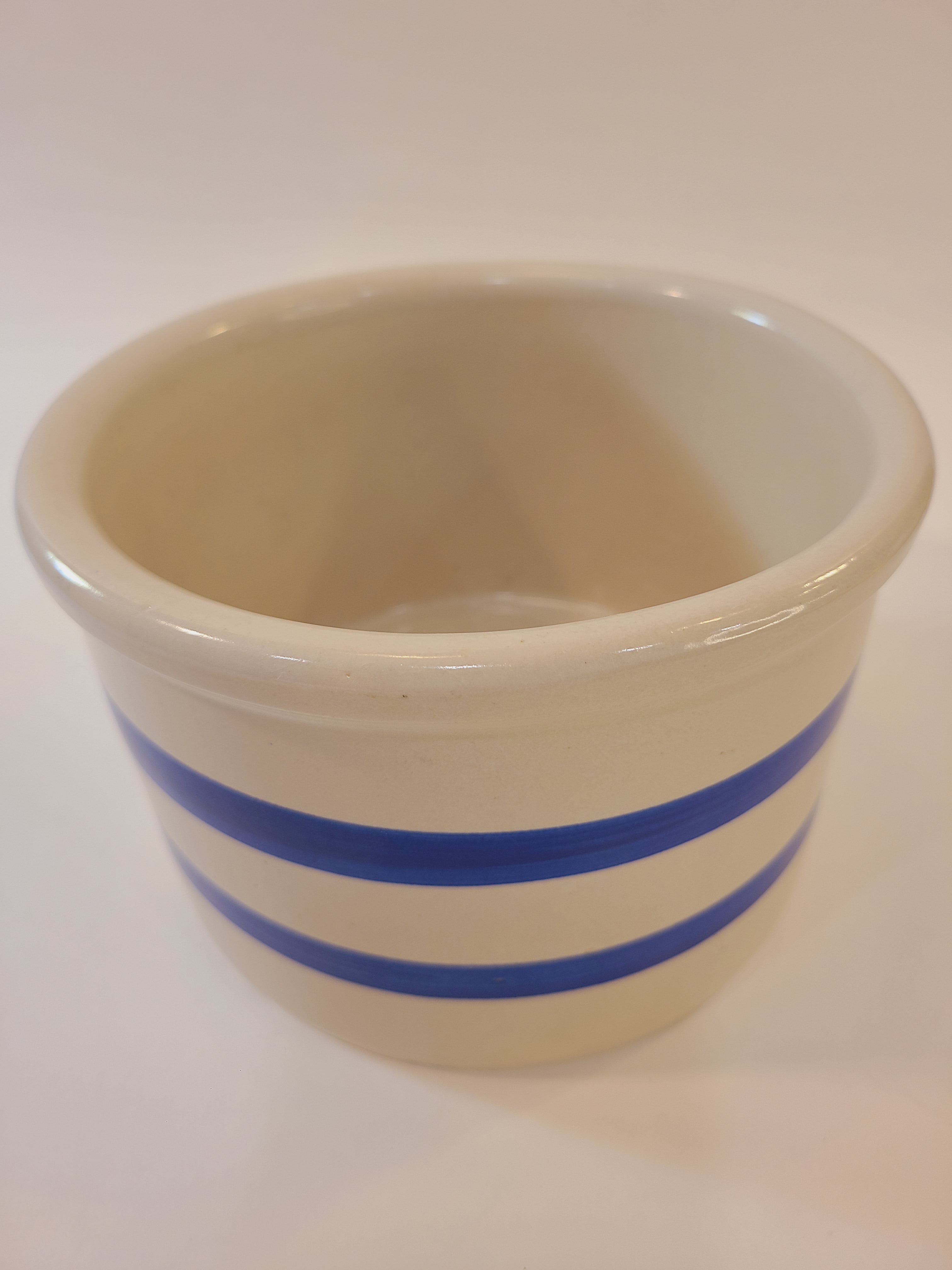 Vintage Robinson Ransbottom Pottery Off-white and Blue Crock on light background.