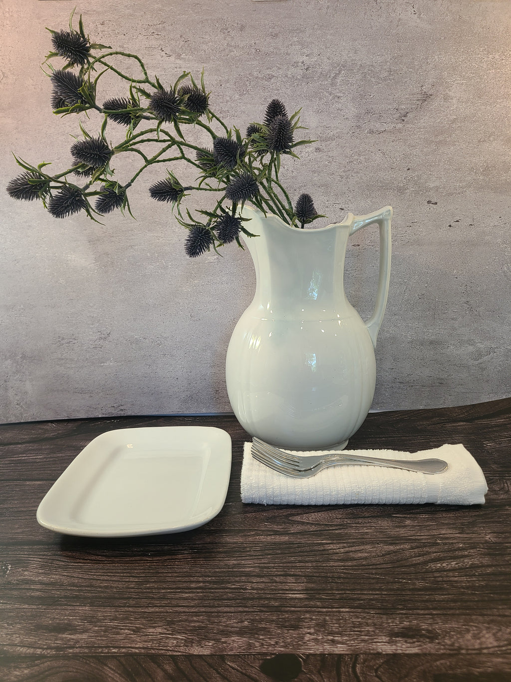 Antique white Alfred Meakin Royal Ironstone Platter photographed from above displayed with ironstone pitcher, silverware, linen napkin.
