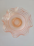 Vintage Blush colored Depression Glass Bowl with Ruffled Edge photographed from directly above.
