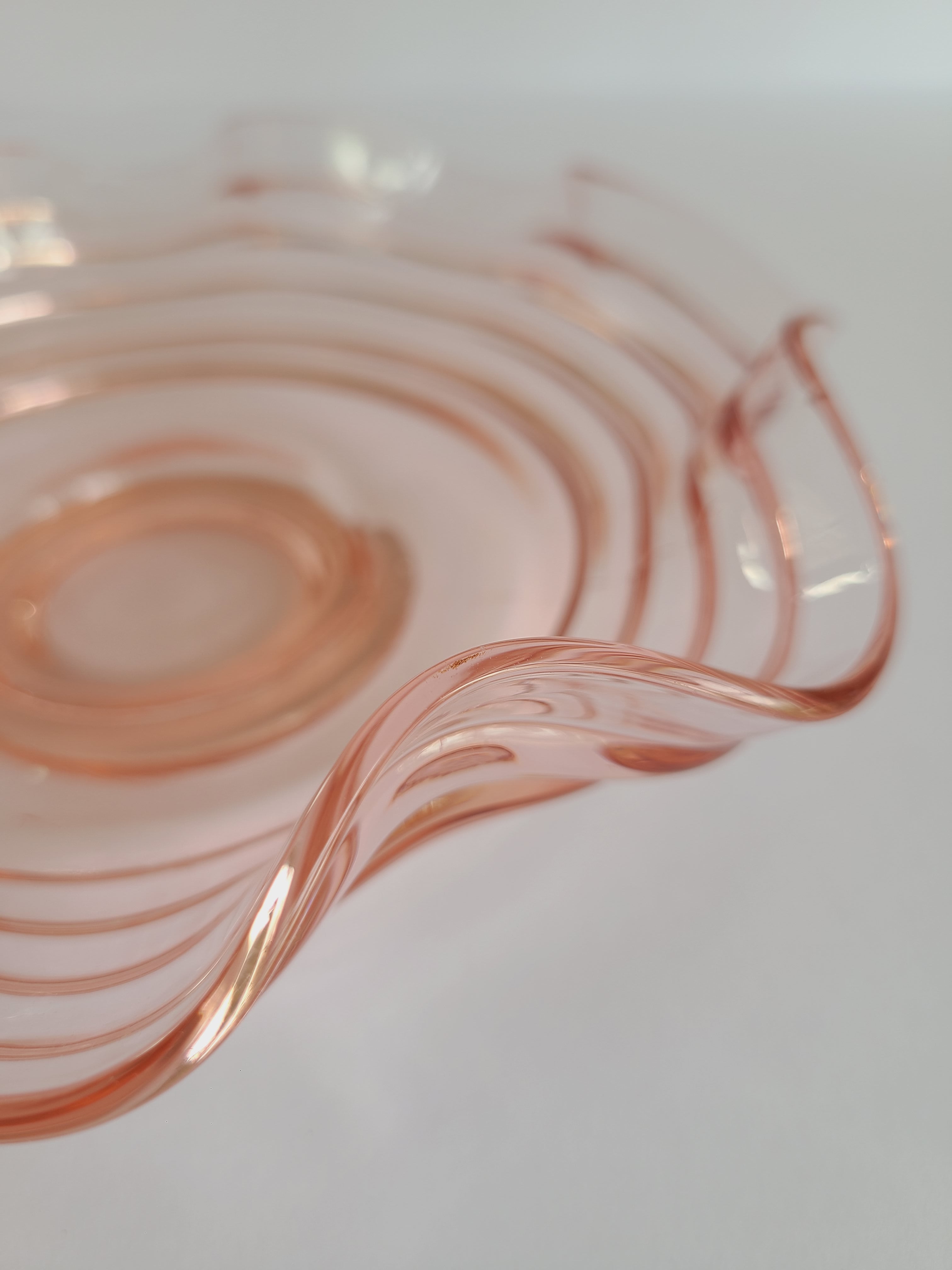 Close up of rim of Vintage Blush colored Depression Glass Bowl with Ruffled Edge.