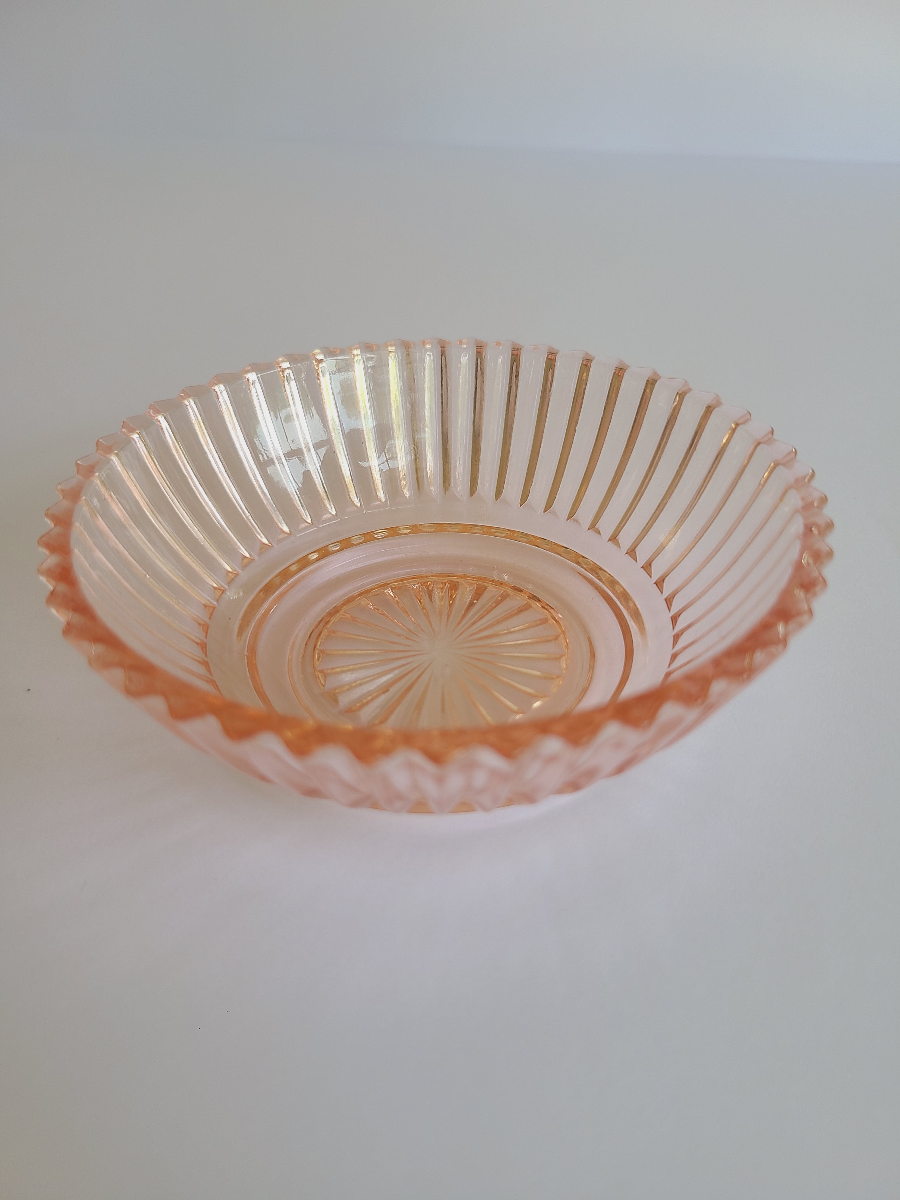 Vintage Blush colored Depression Glass Bowl with Ridged Detailing photographed from the side