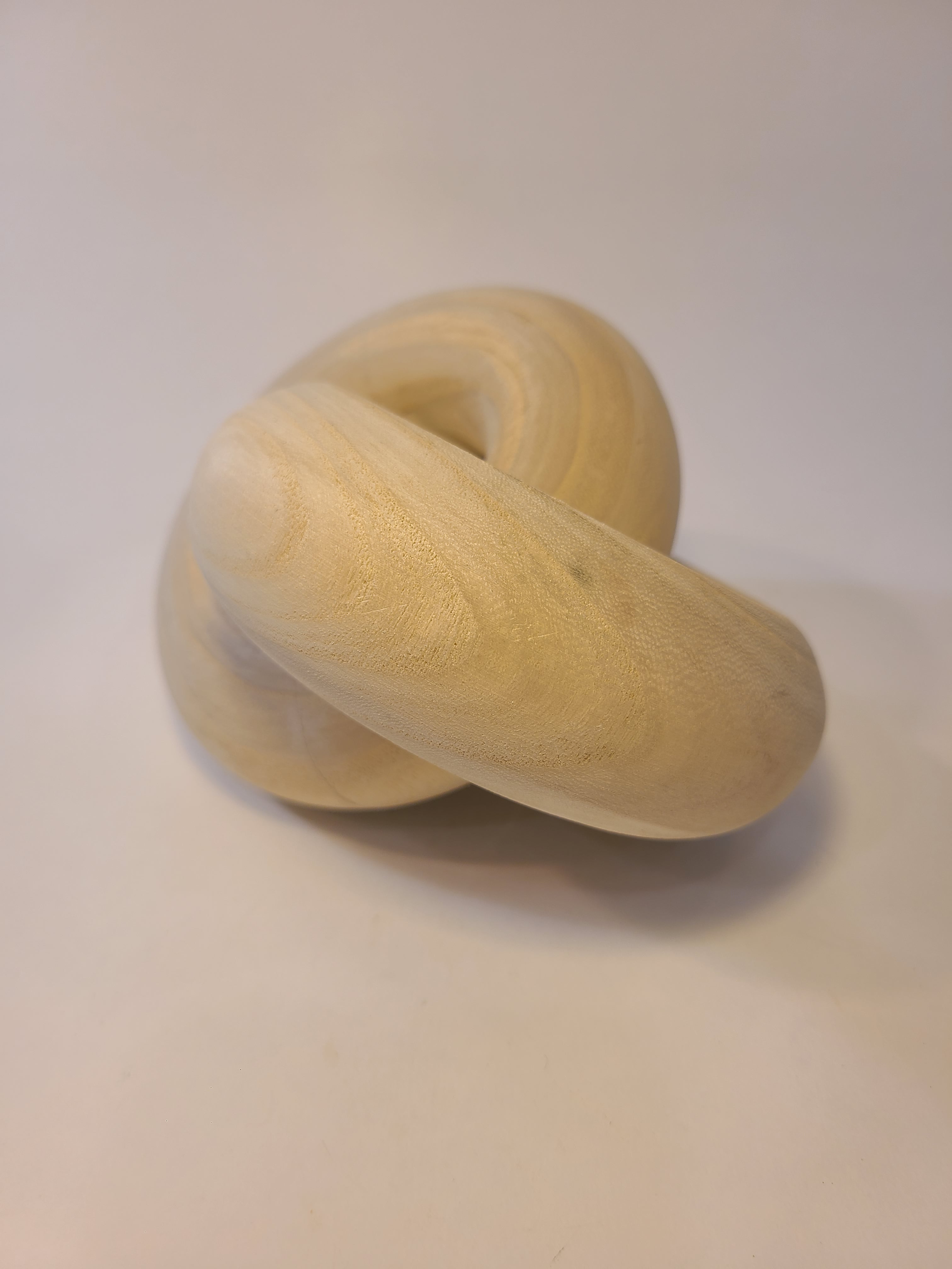 Light natural wood interlocking rings decor item.