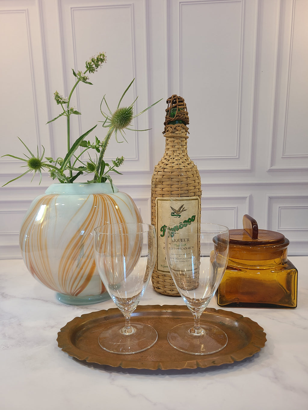 Vintage copper serving tray holding glasses.