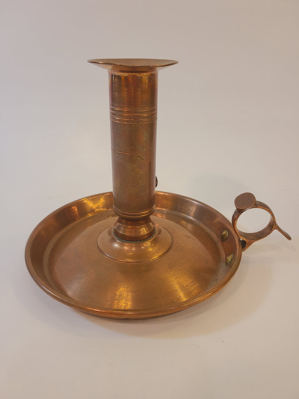 Antique Copper Candle Holder with Push-Up Lever on white background