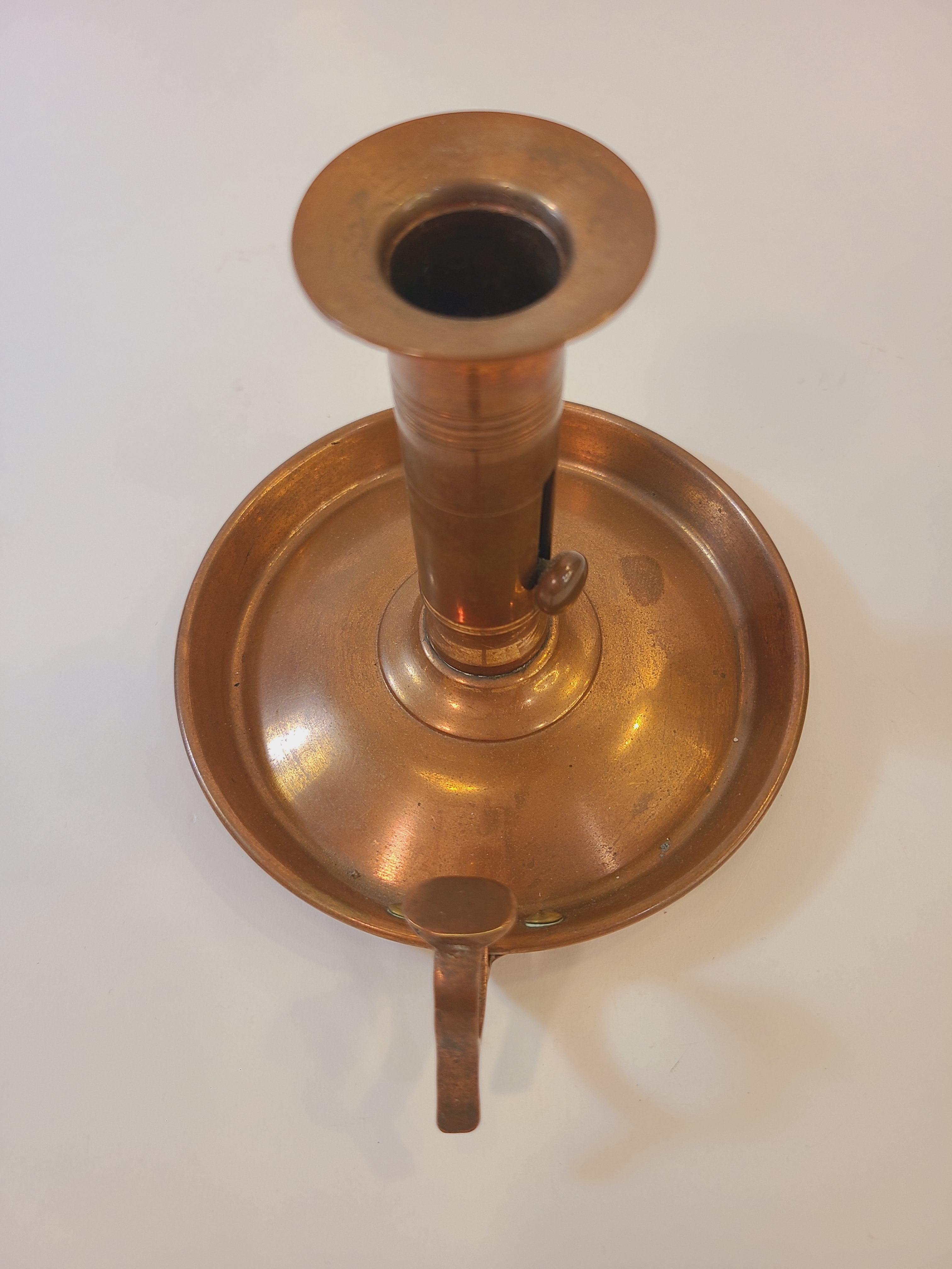 Antique Copper Candle Holder with Push-Up Lever photographed from above