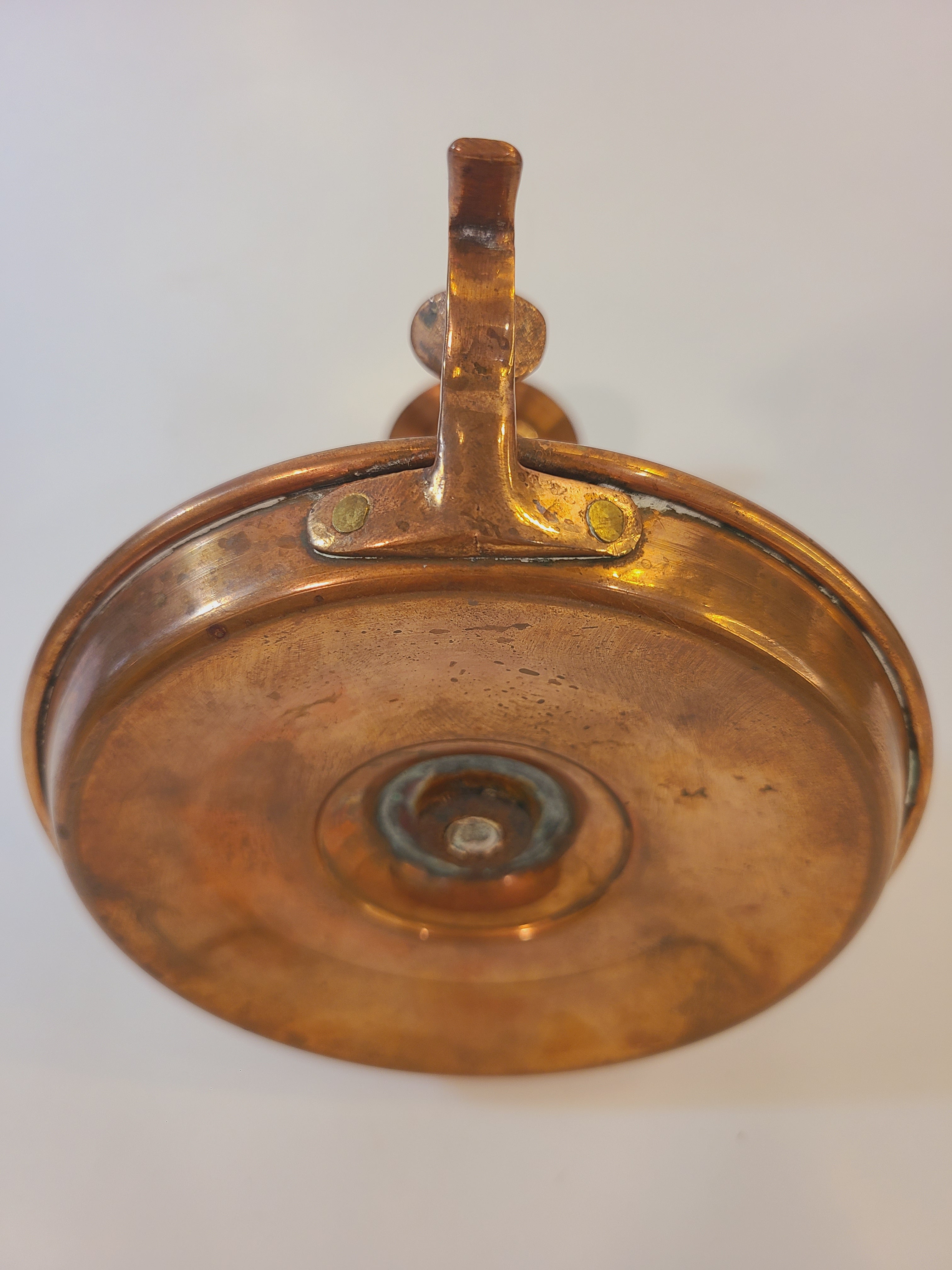 Antique Copper Candle Holder with Push-Up Lever photographed to show brass thumb loop