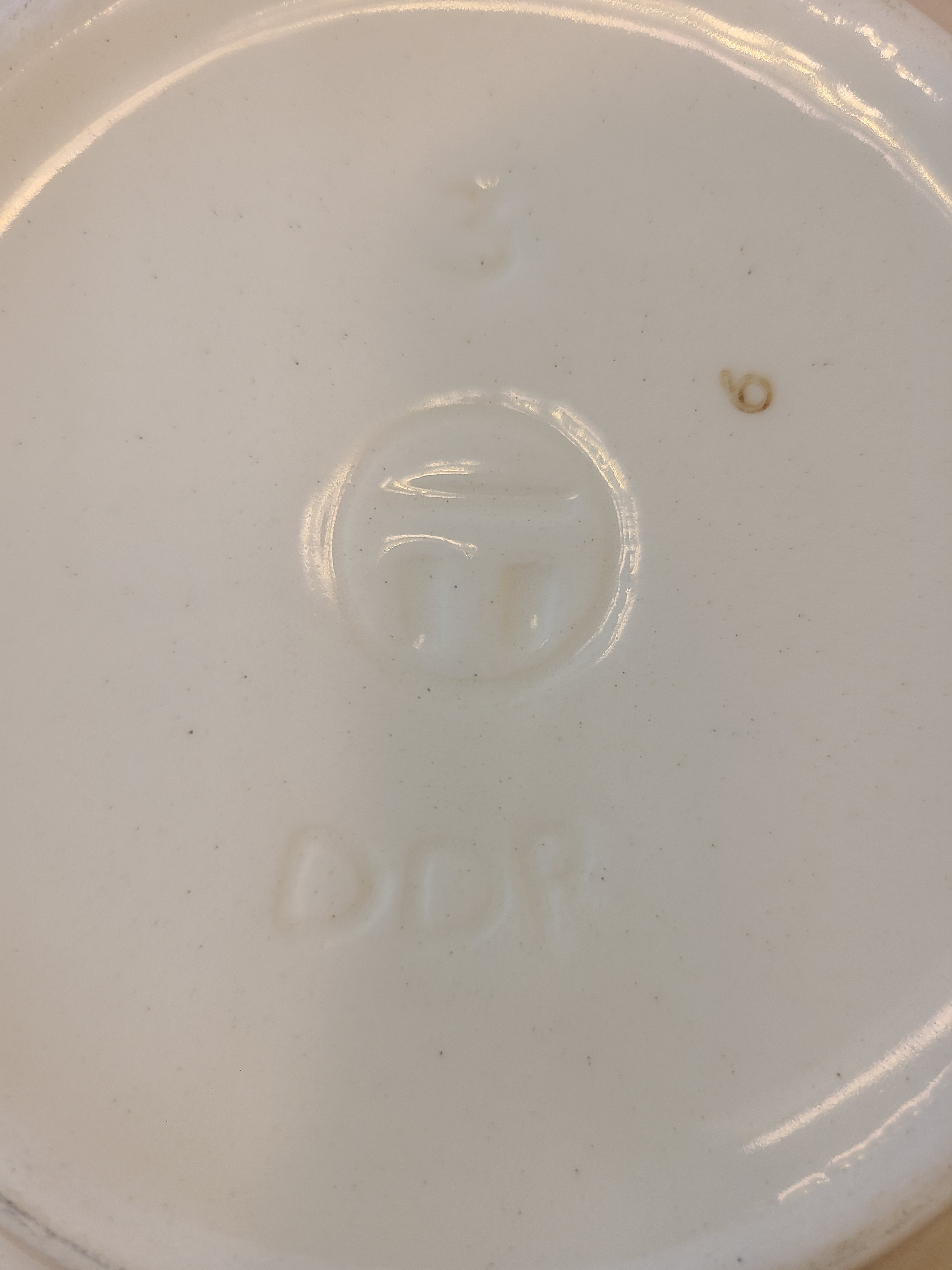 Close up of bottom of vintage ceramic bowl showing DDR mark made in East Germany.