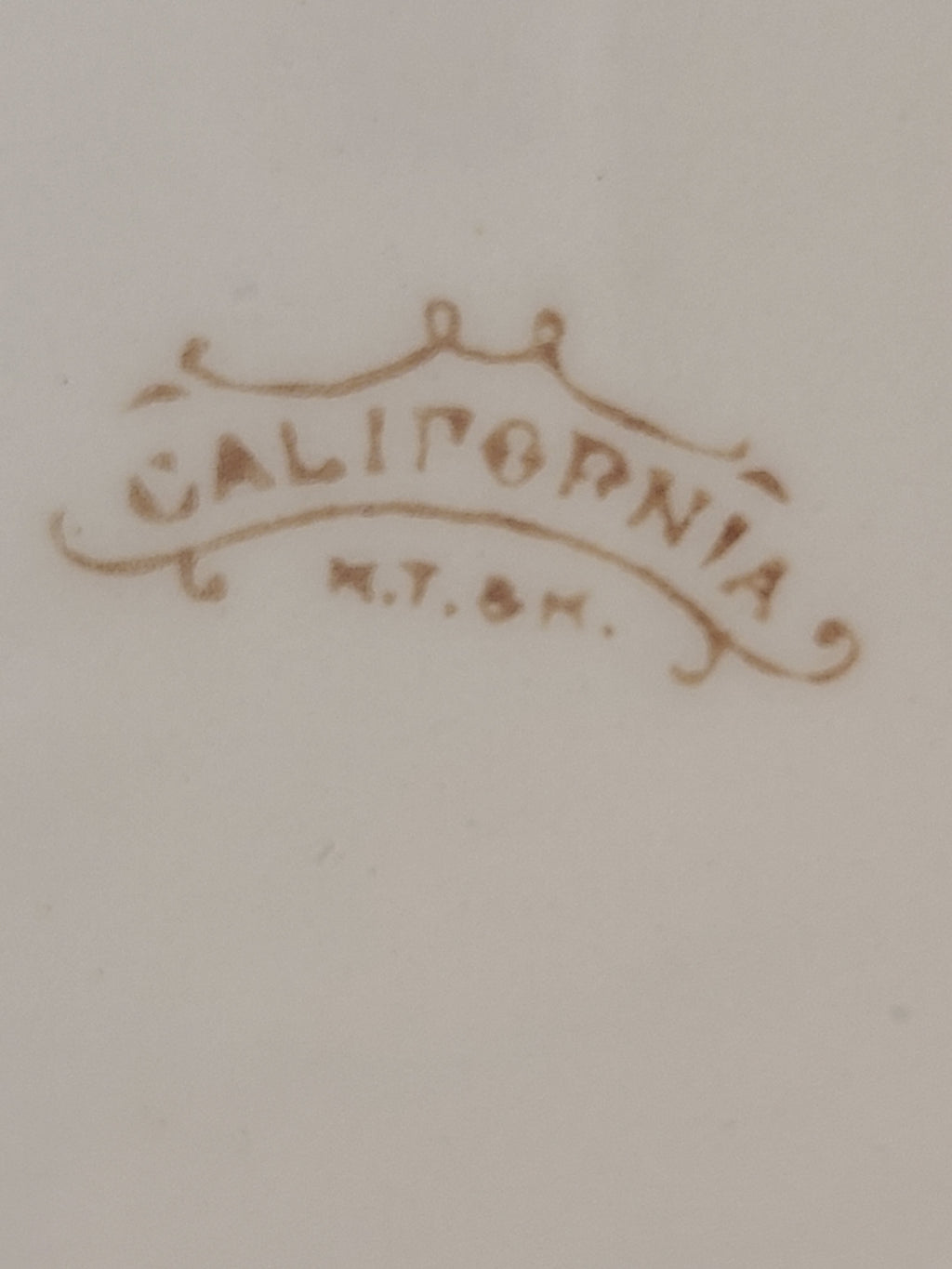 Close up of logo of Antique Mellor, Taylor & Co. English Ironstone Chamber Pot