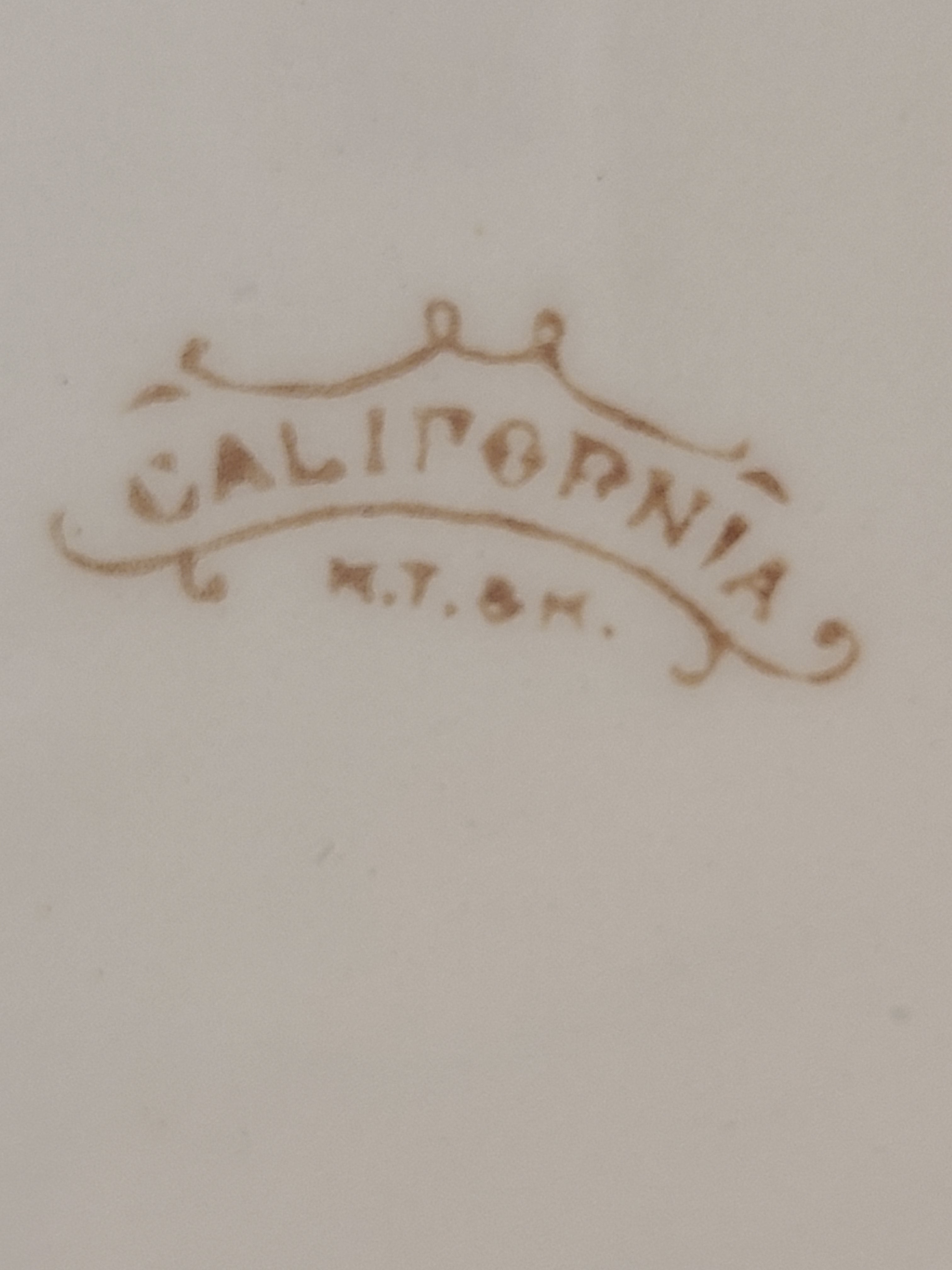 Close up of logo of Antique Mellor, Taylor & Co. English Ironstone Chamber Pot