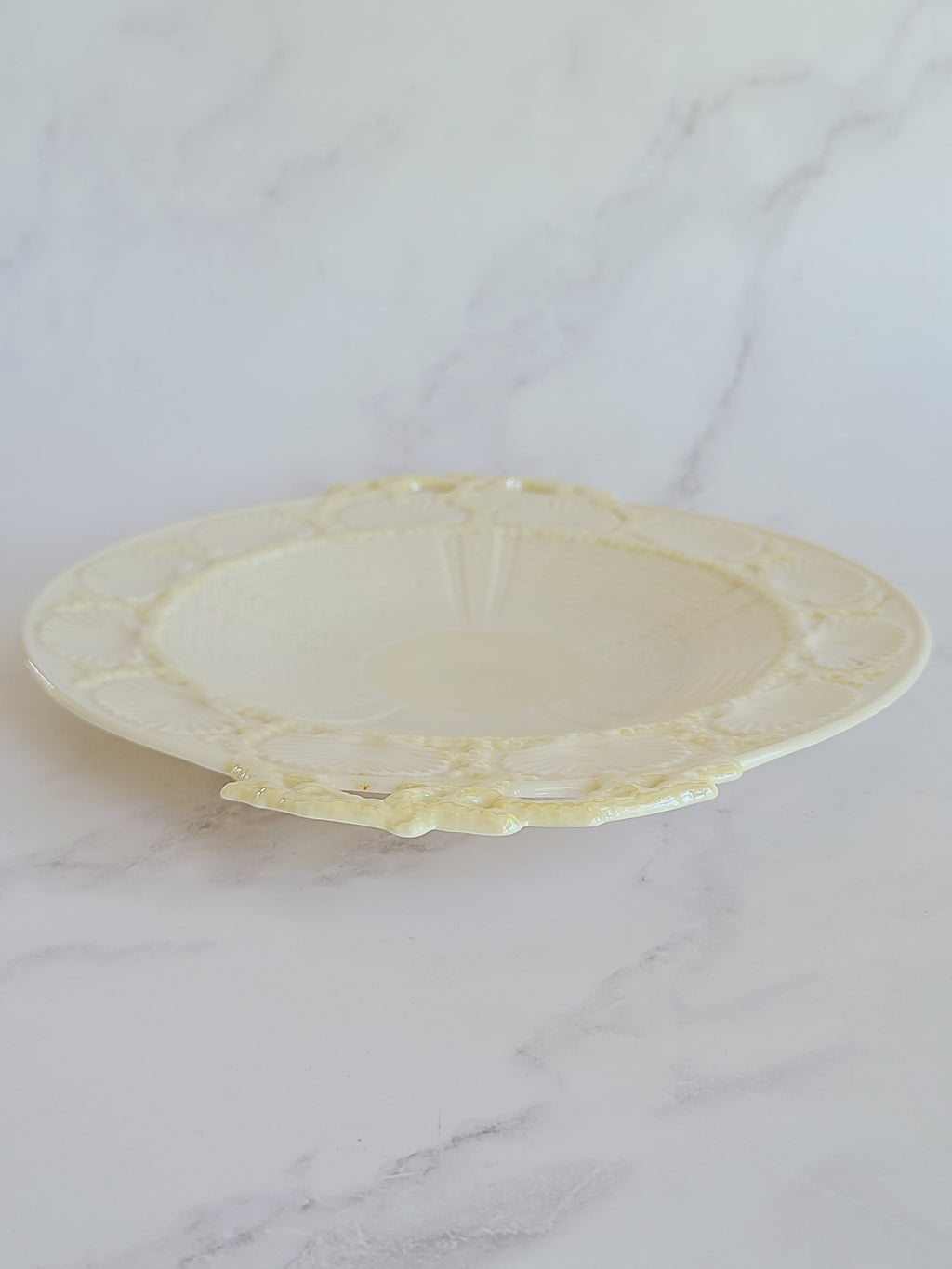 Vintage Belleek Porcelain Plate with Shell Motif shown from side